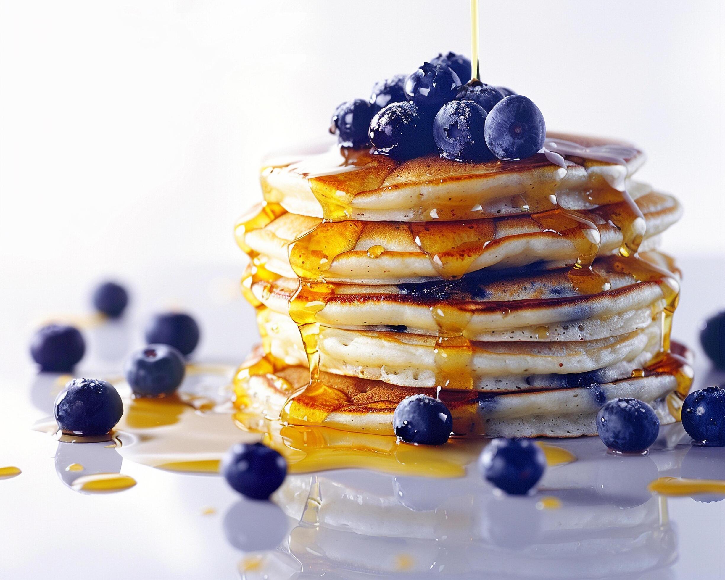 a stack of pancakes with syrup and blueberries Stock Free