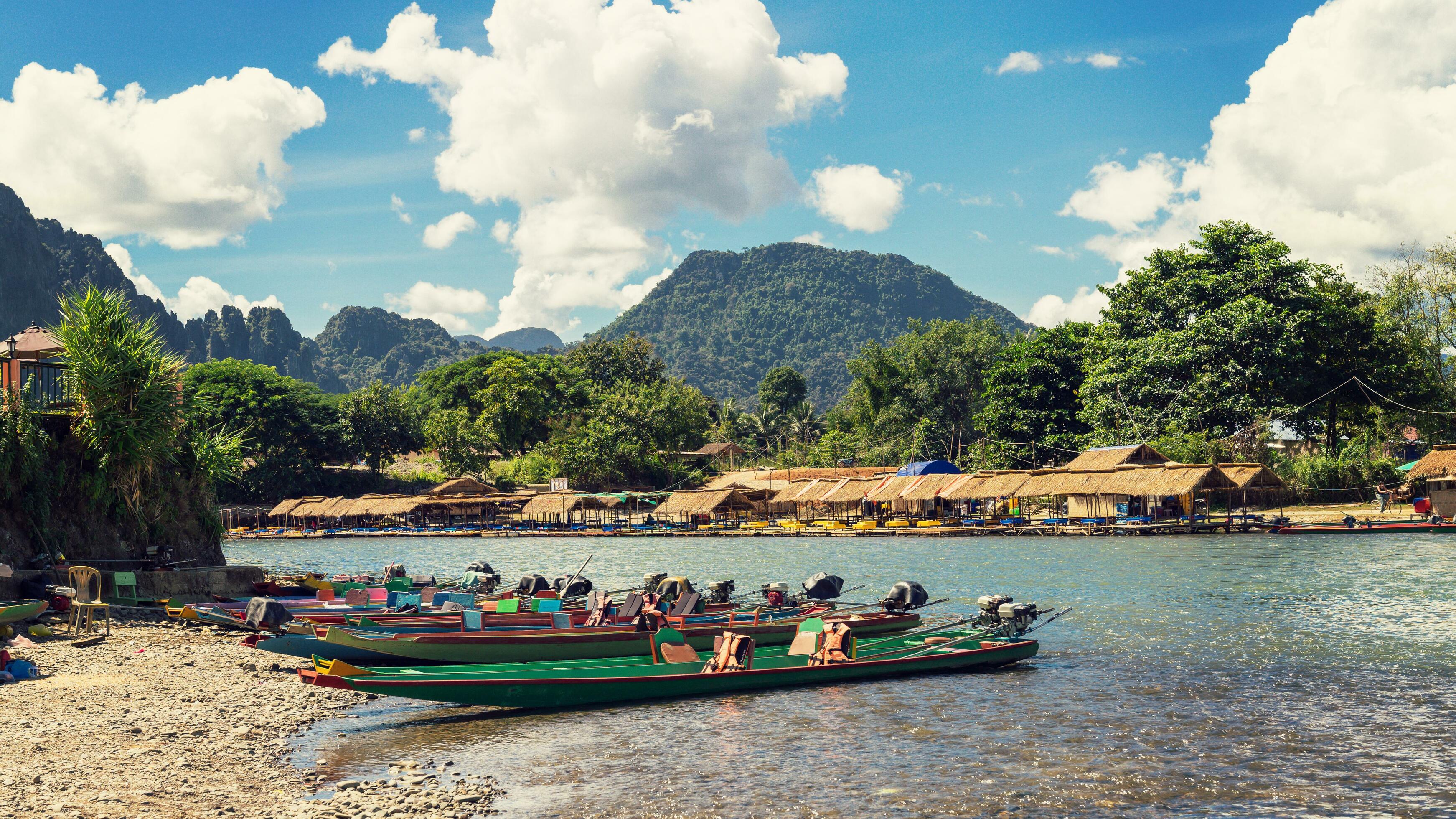 long tail boats on sunset at Song river, Vang Vieng, Laos. Stock Free