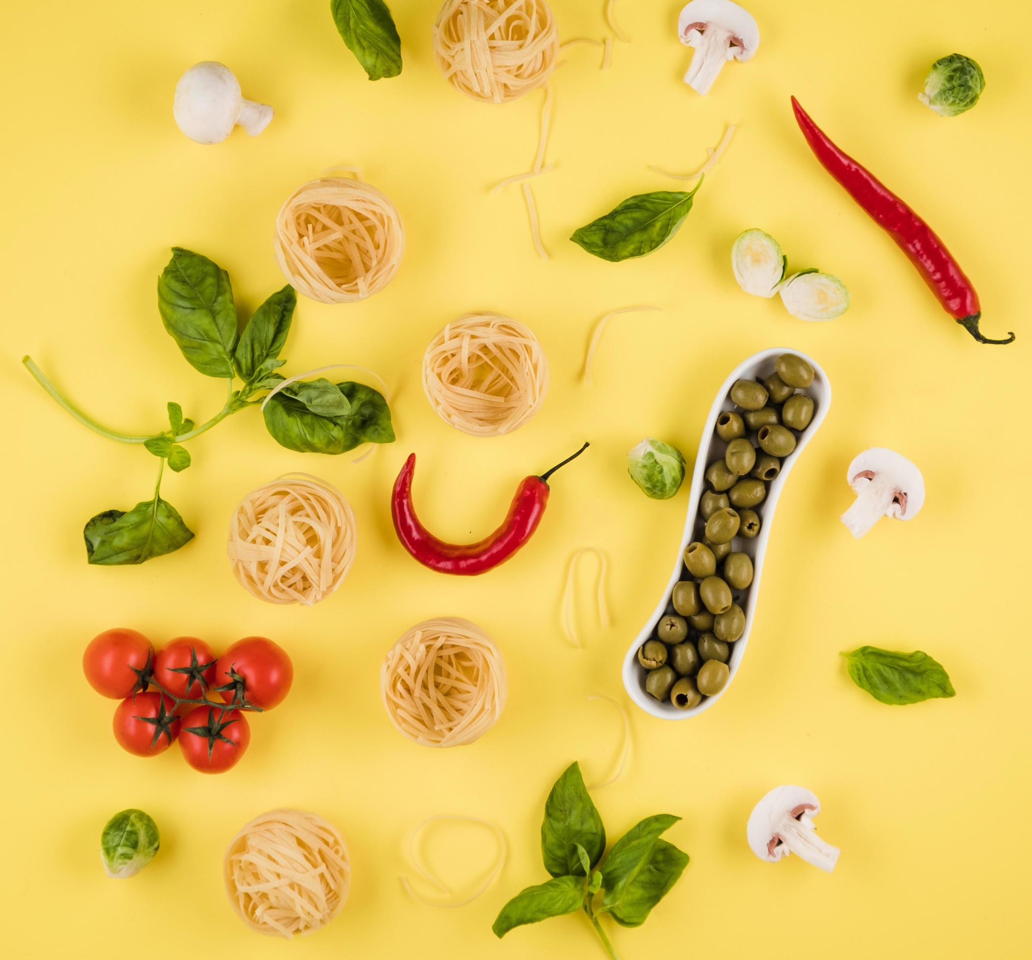 Top view, delicious ingredients laid out on yellow background. concept of cooking italian food Stock Free