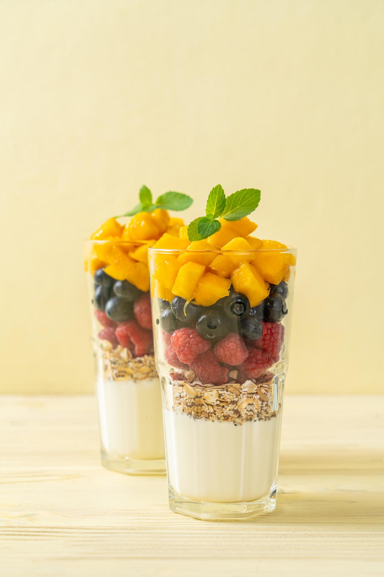 Homemade mango, raspberry, and blueberry with yogurt and granola – healthy food style Stock Free