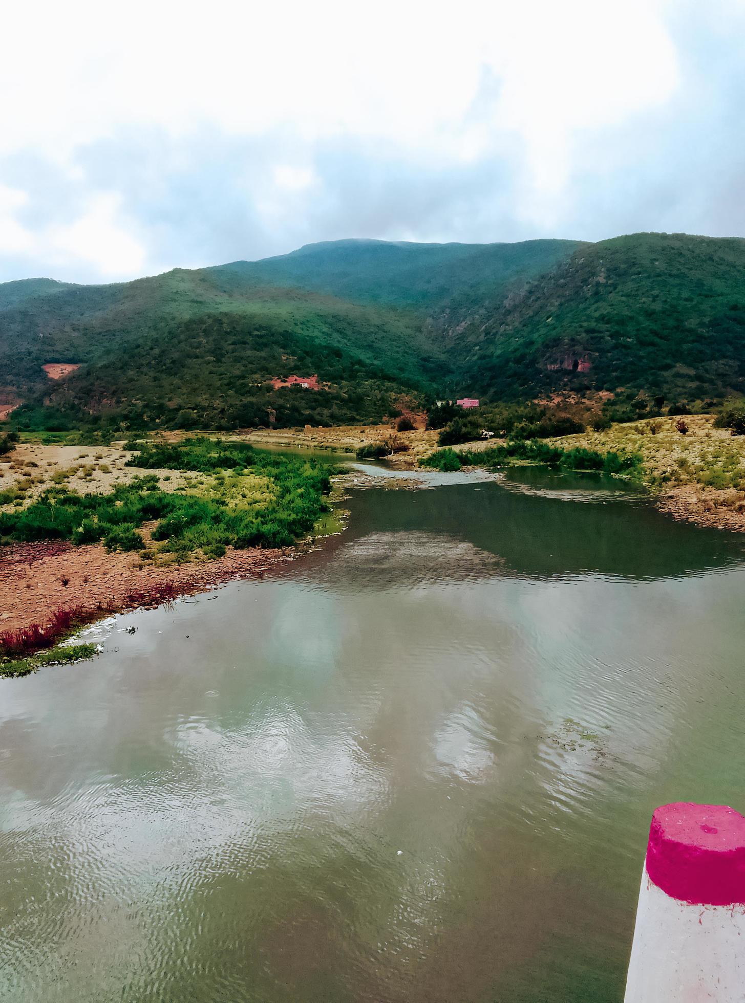 Majestic landscape of a small lake in front of a mountain with cloudy sky a journey into the heart of nature’s tranquil and breathtaking views Stock Free