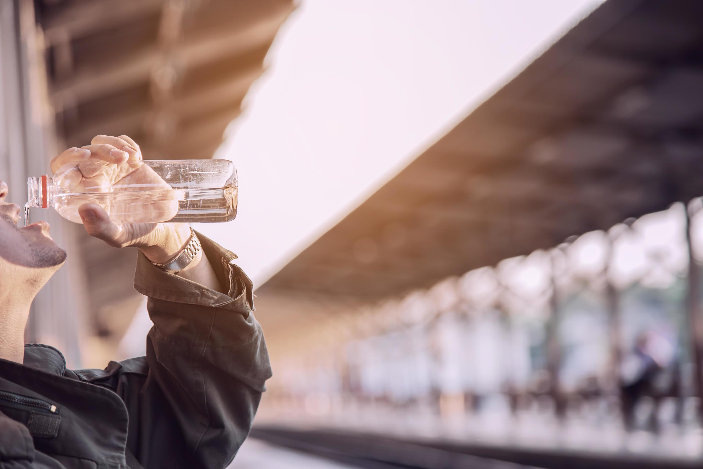 Travel man wait train at platform – people vacation lifestyle activities at train station transportation concept Stock Free