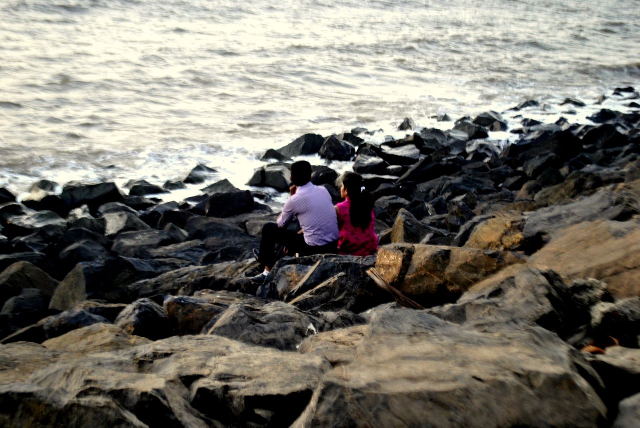 Couple Sitting Rocks Sea Stock Free