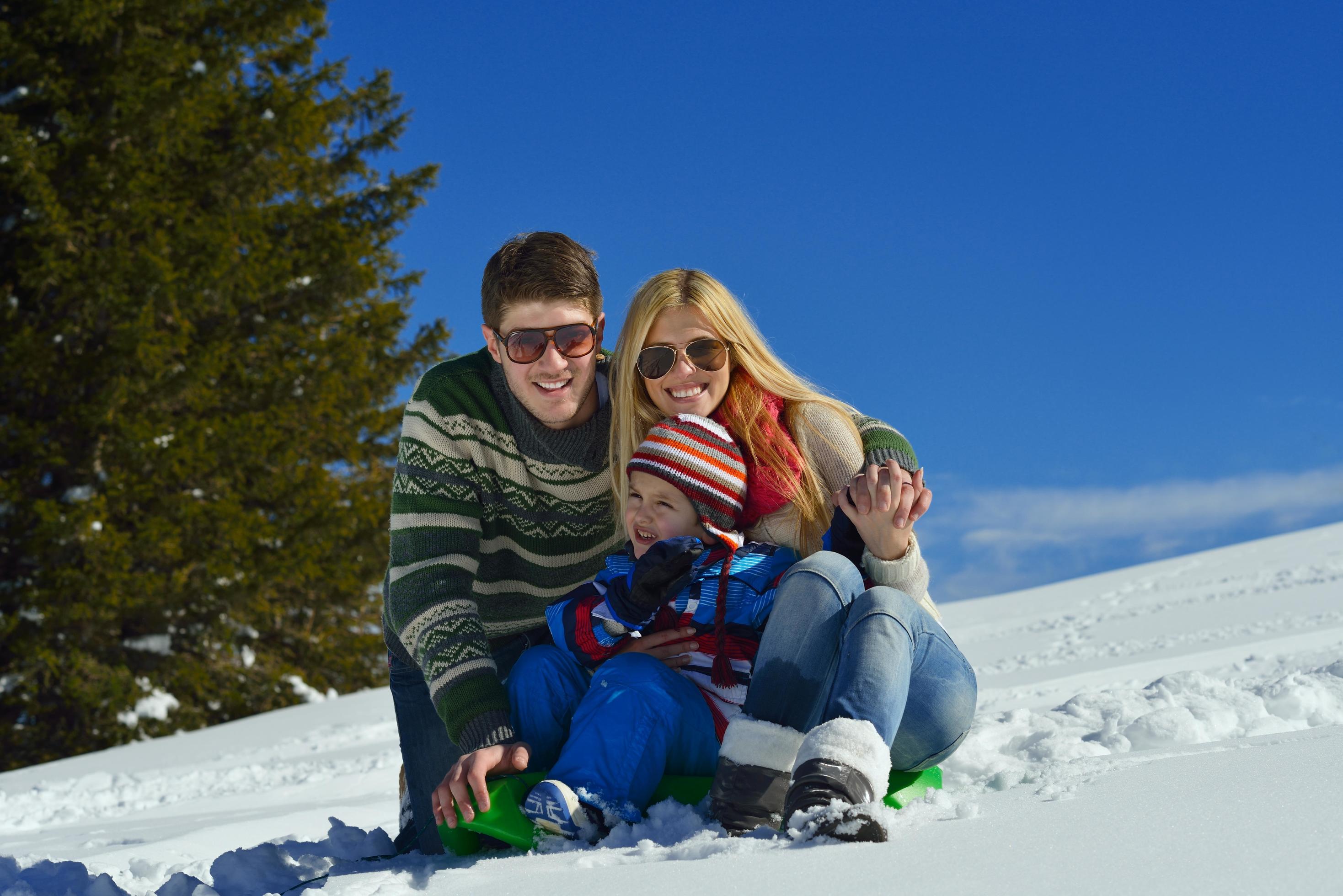 family having fun on fresh snow at winter Stock Free