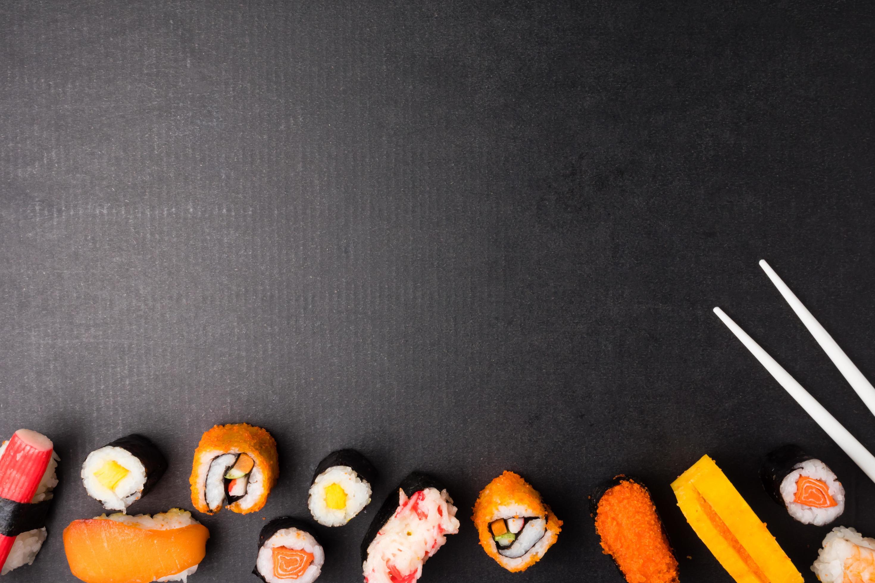 Top view of Sushi set and chopsticks on black background, Japanese food. Free space for text Stock Free