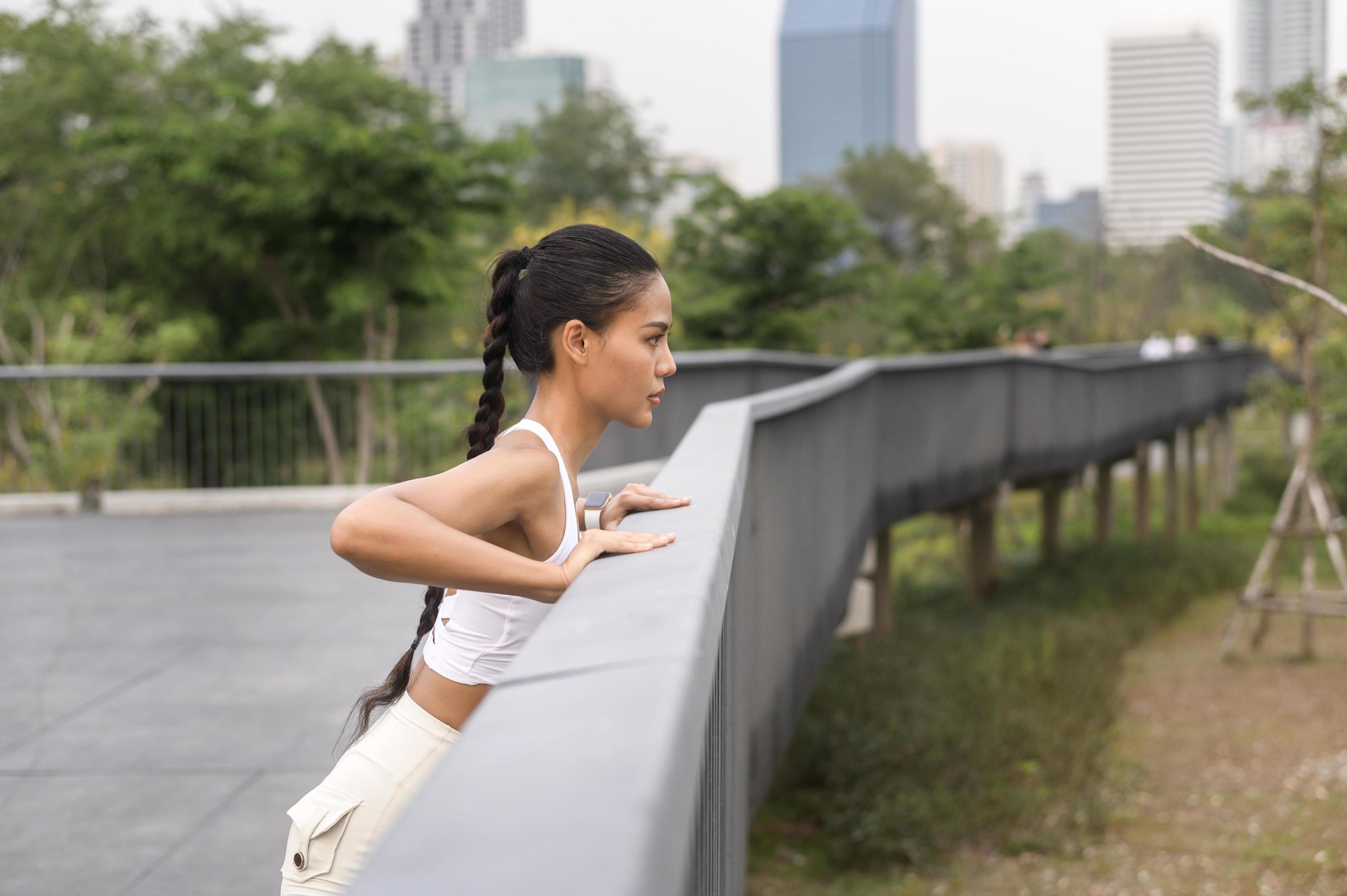 A young fitness woman in sportswear exercising in city park, Healthy and Lifestyles. Stock Free