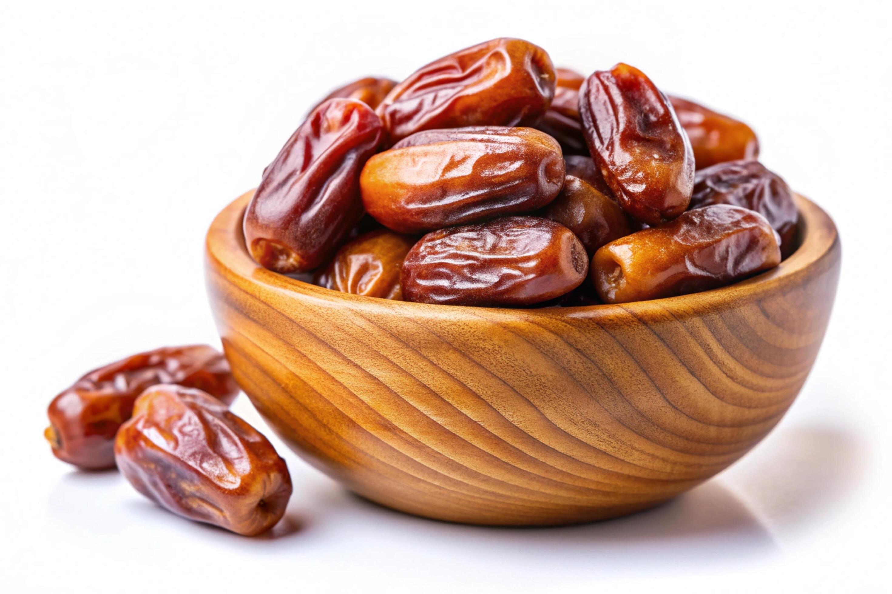 Dates in wood bowl isolated on white background Stock Free