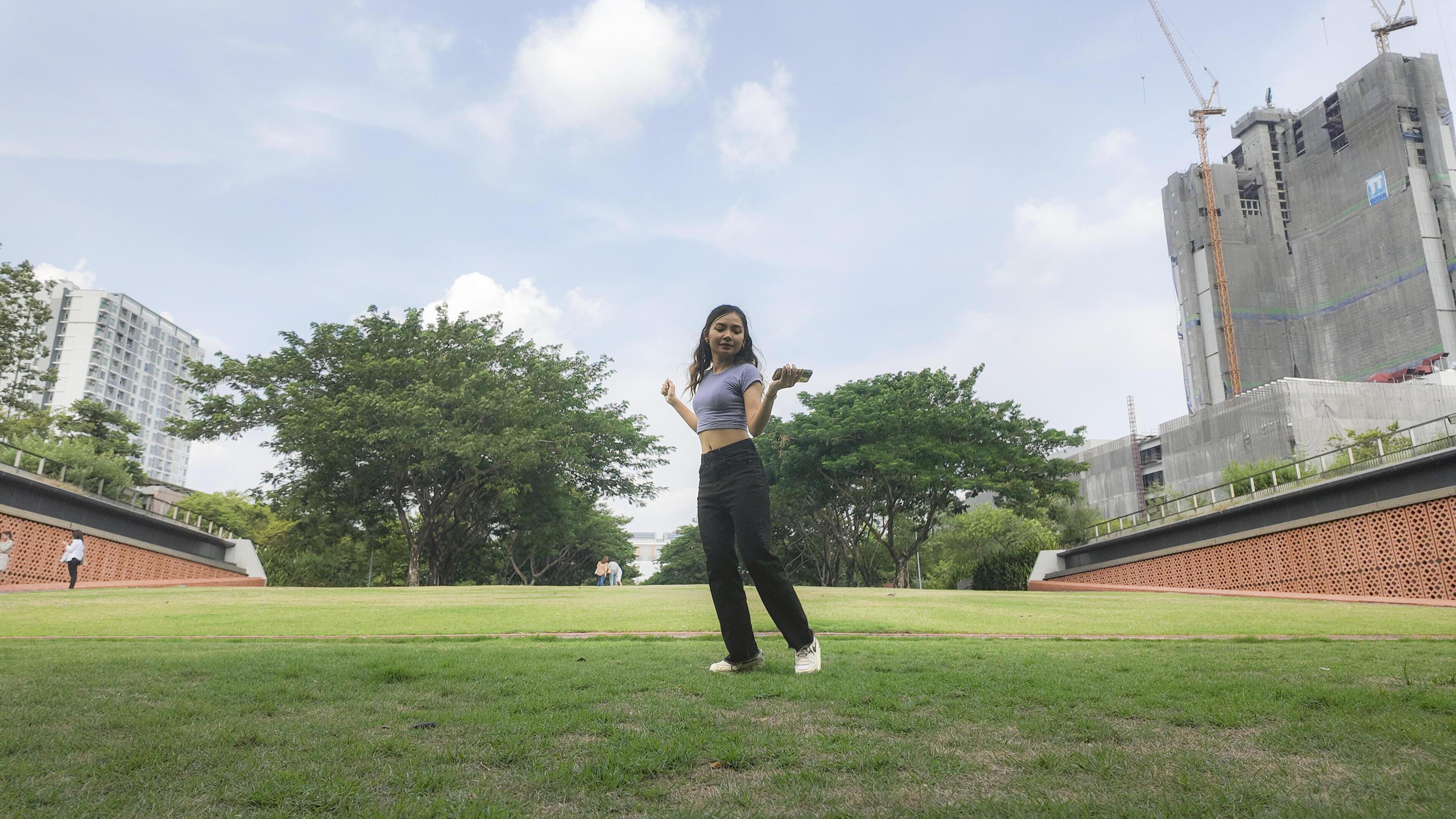 Asian women do freestyle hip hop and breakdancing in a public space in the middle of the city. With a cheerful and happy attitude Stock Free