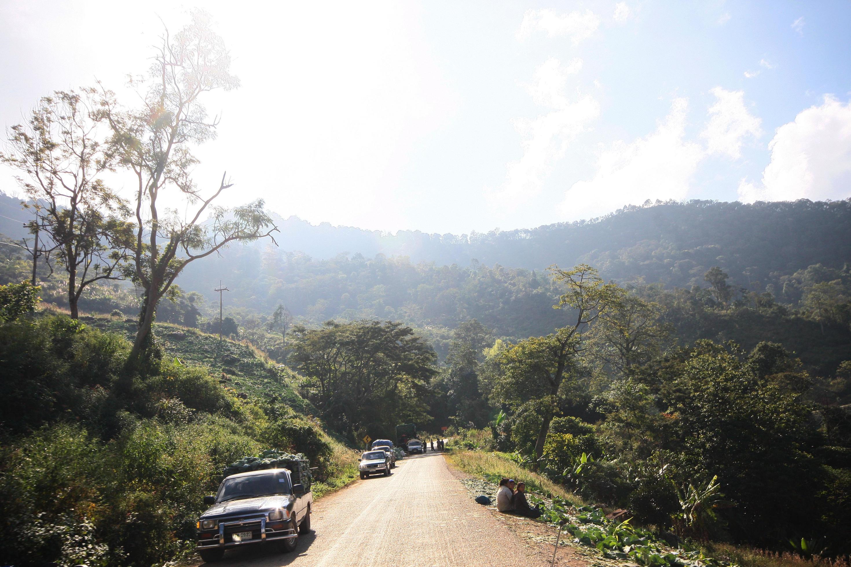 Life of hill tribe farmers and car parking beside country road on the mountain in Thailand Stock Free