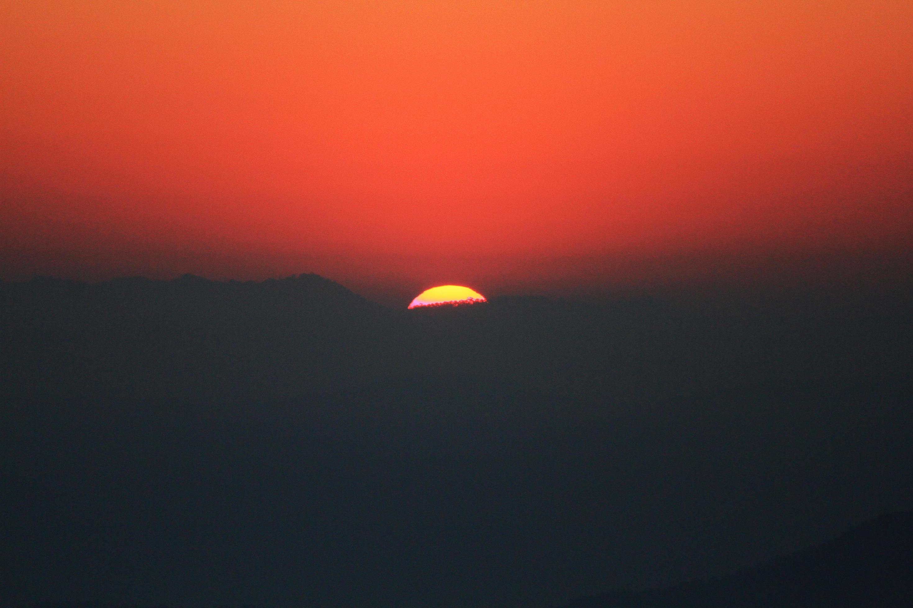 Sunset in sky and cloud, beautiful colorful twilight time with silhouette of mountain. Stock Free