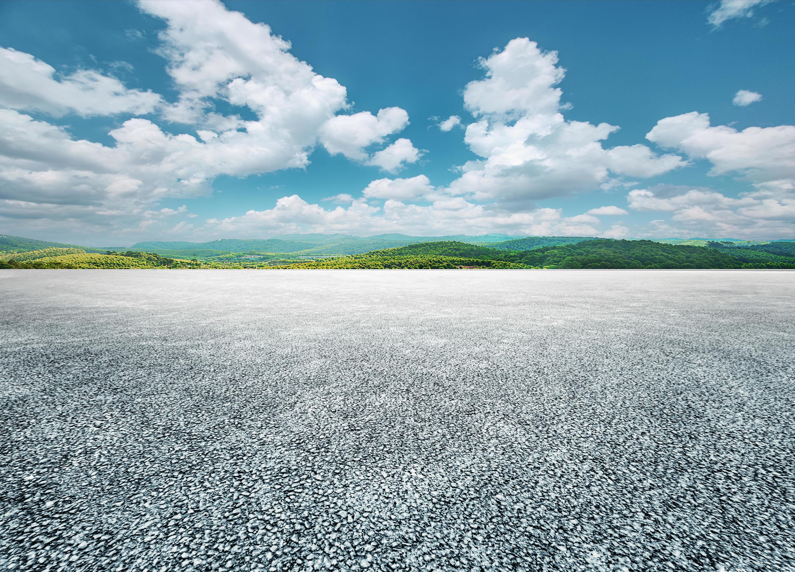 Asphalt road and green mountain nature landscape under blue sky with white clouds Stock Free