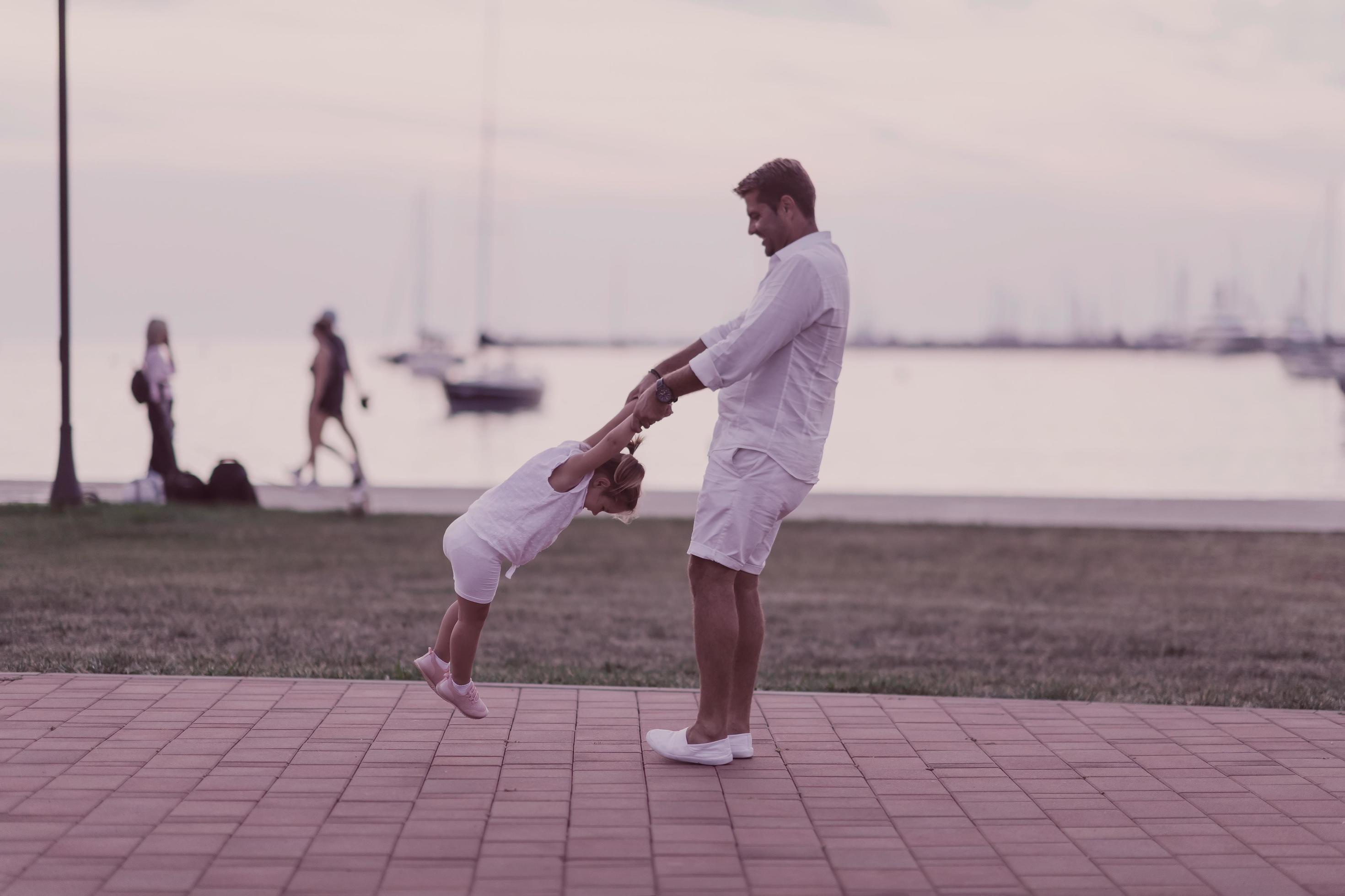 An elderly man in casual clothes with his daughter spends time together in the park on vacation. Family time. Selective focus Stock Free