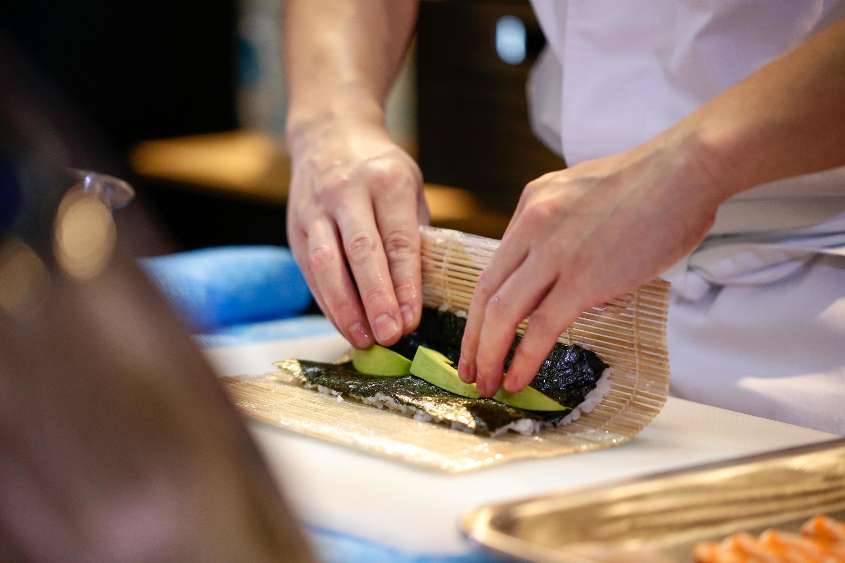 chef hands preparing japanese food, chef making sushi Stock Free