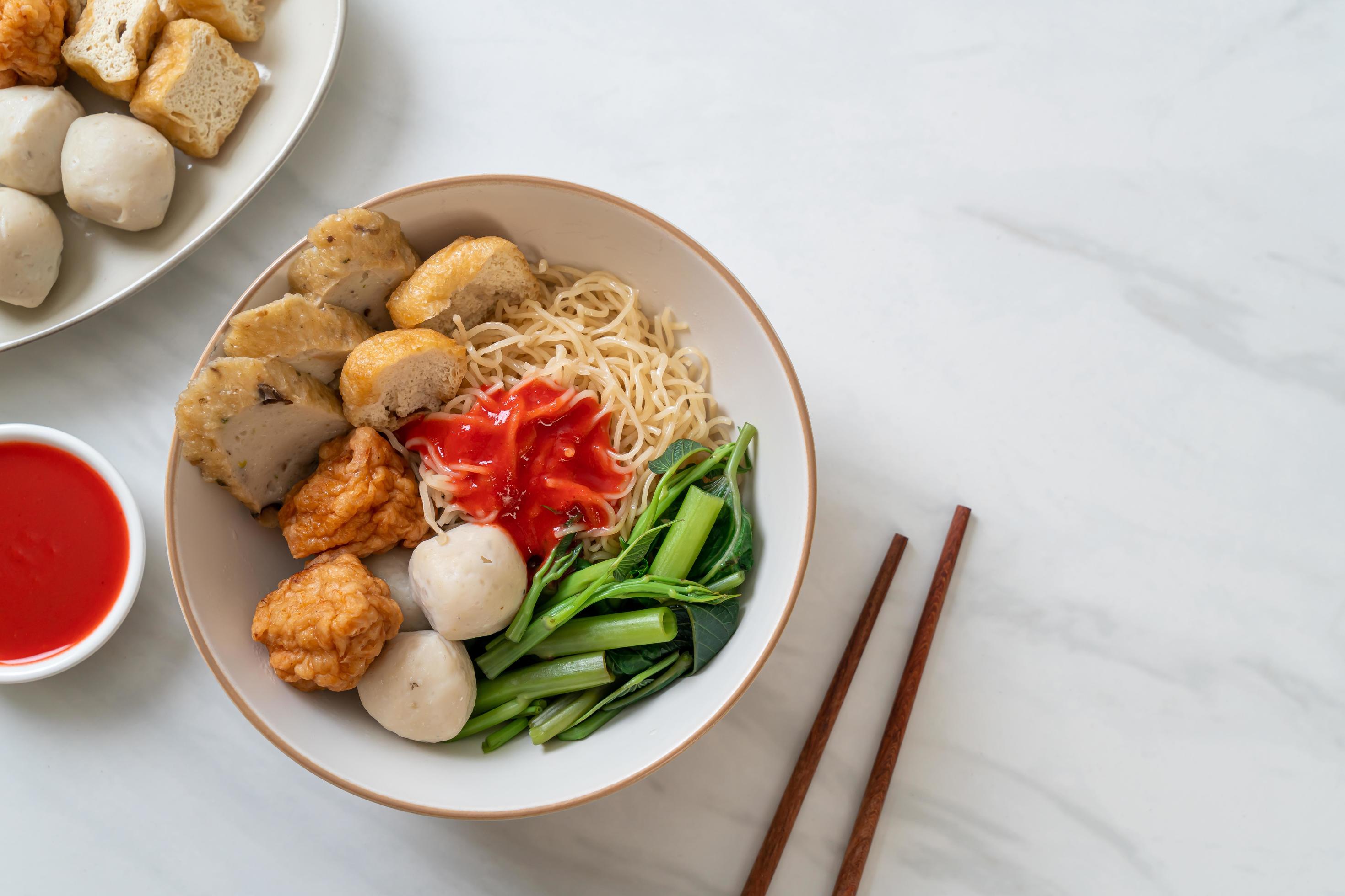 Egg noodles with fish balls and shrimp balls in pink sauce, Yen Ta Four or Yen Ta Fo – Asian food style Stock Free