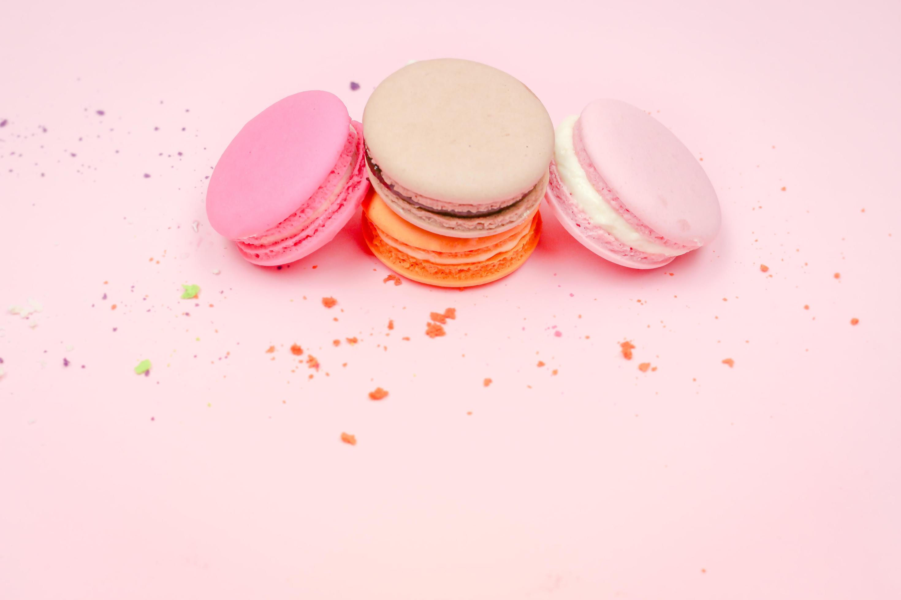 Colorful french macarons macaroons cake, delicious sweet dessert on a pink background with copyspace, food background concept. Stock Free