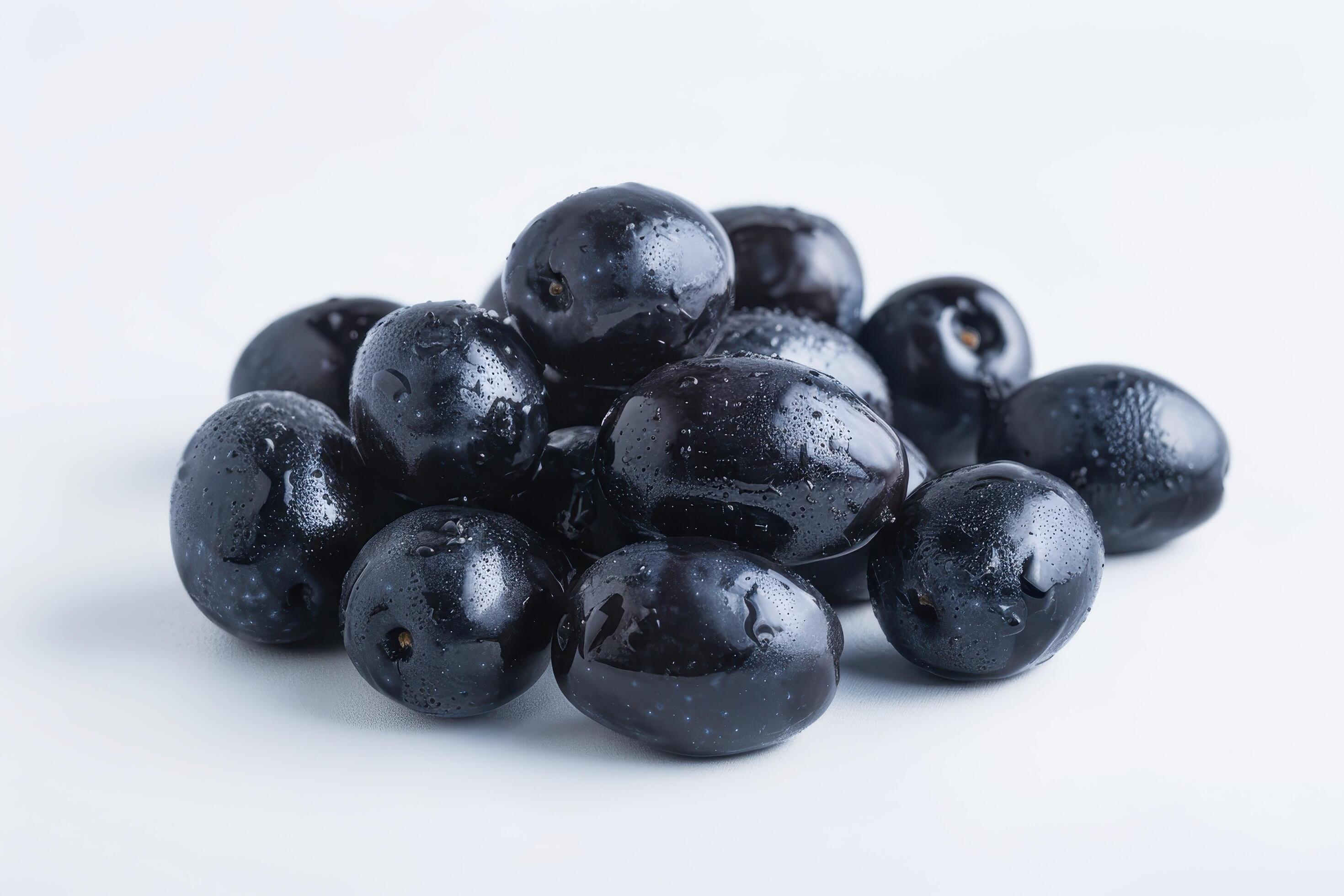 Pile of Dark Blue Plums with Water Droplets on White Background Stock Free