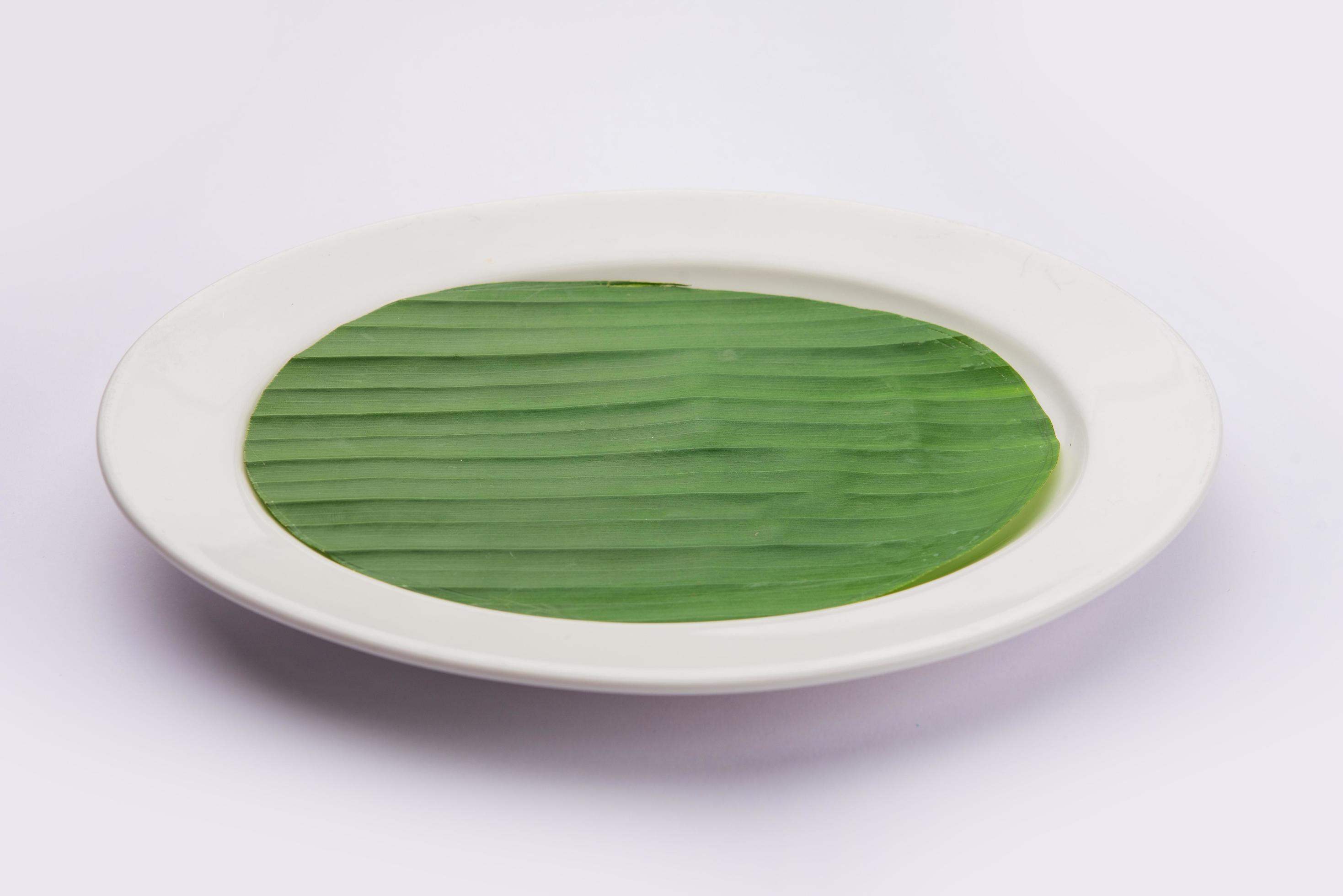 banana leaf on blank plate for edit food or subject on Stock Free