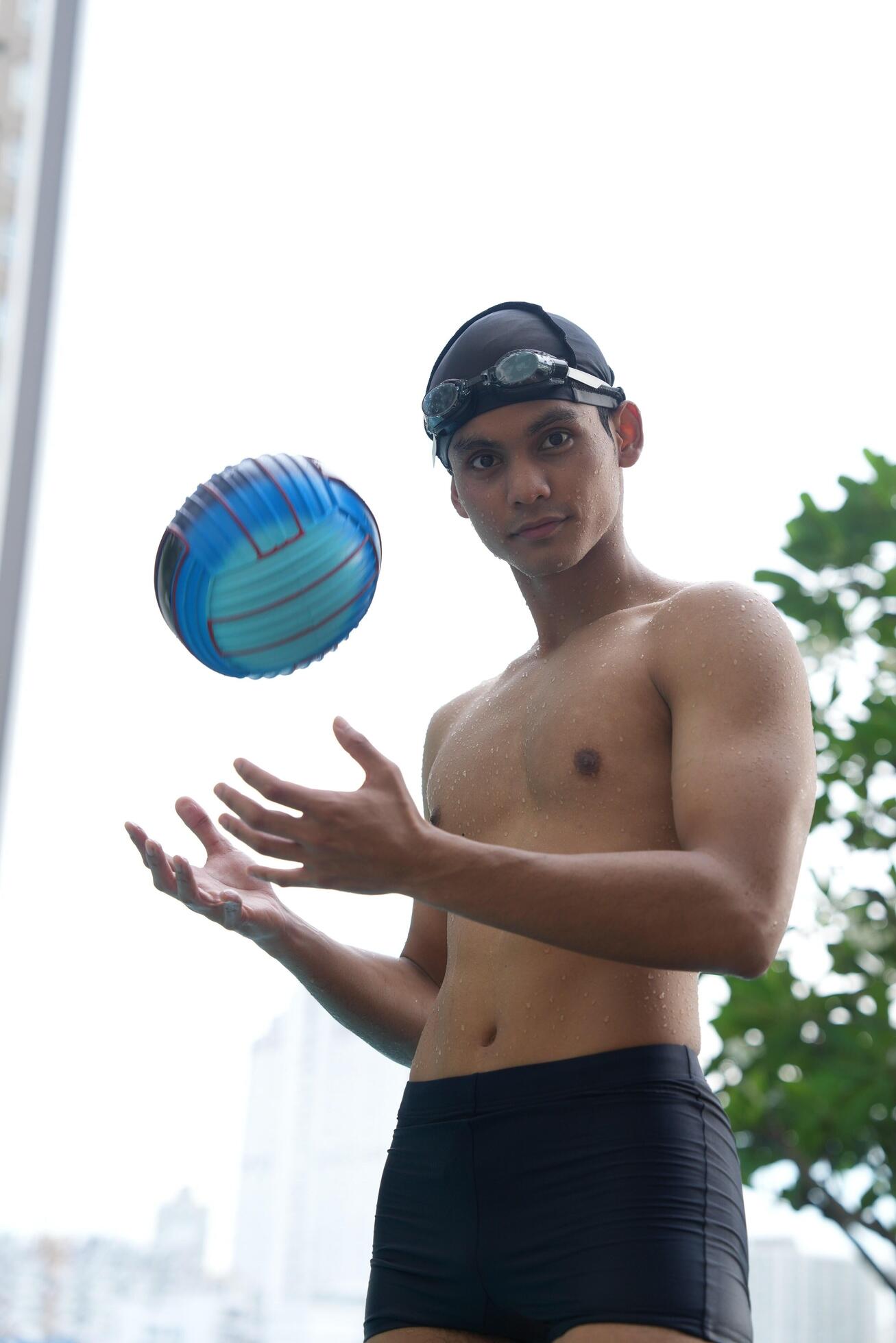 Asian men practicing swimming and preparing to play water polo and stretching and resting for water sports. Stock Free