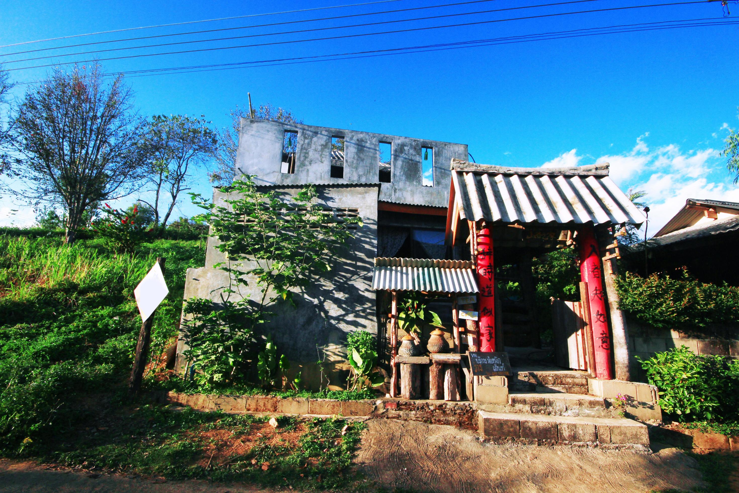 Yunnan Chinese hilltribe houses on the mountain with beautiful blue sky and sunlight in northern Thailand Stock Free