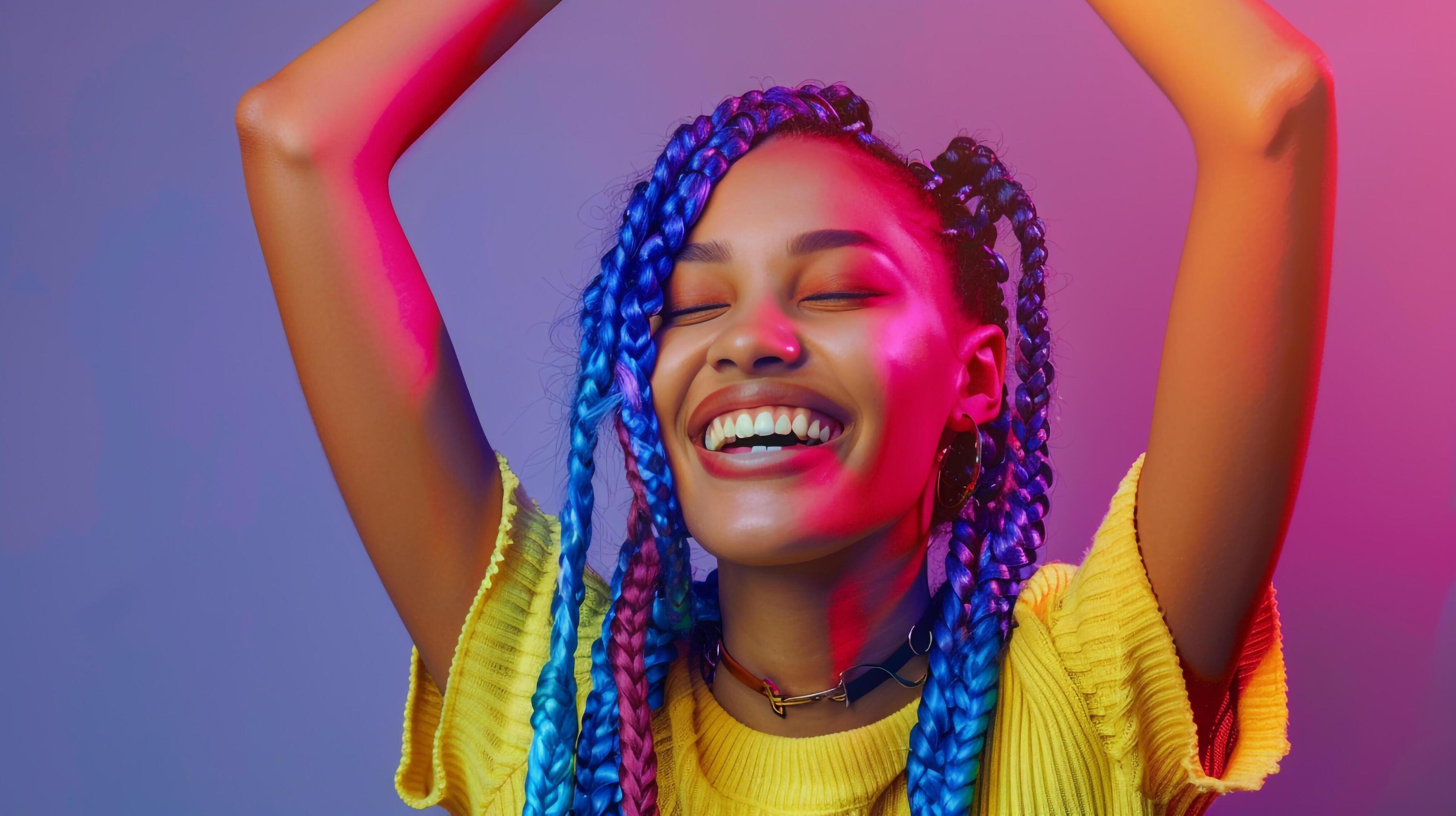 Woman colorful hair yellow shirt smiling arms up Stock Free