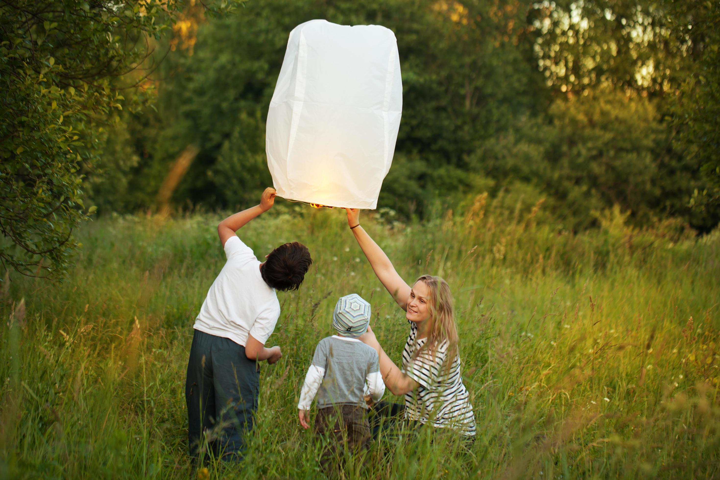 Family lighting a paper lantern Stock Free