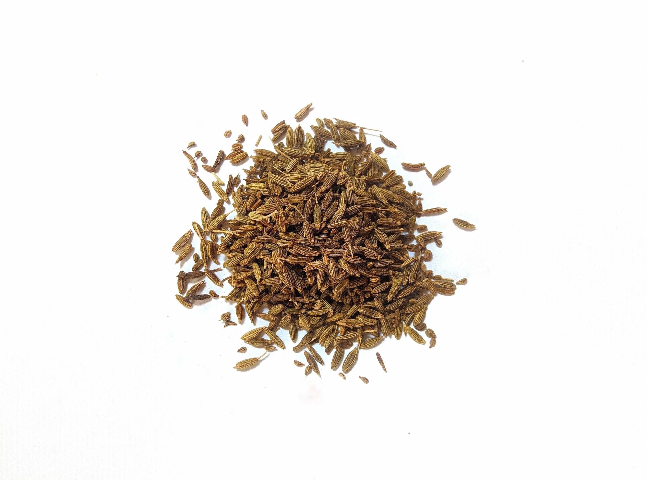 Pile of cumin seeds isolated on white background Stock Free