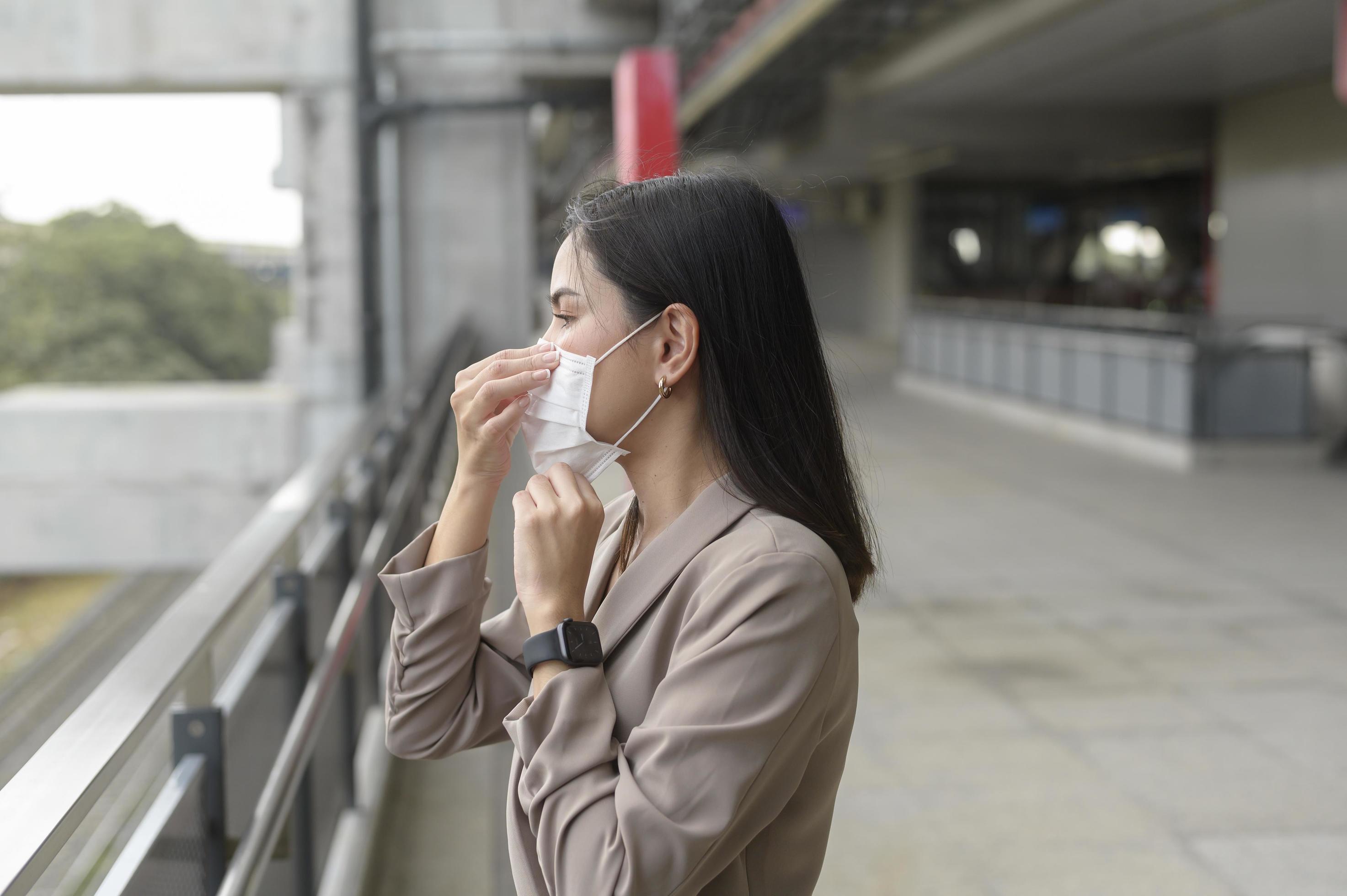 A portrait of Businesswoman is wearing face mask work in modern City , people lifestyle , working under Covid-19 pandemic concept Stock Free