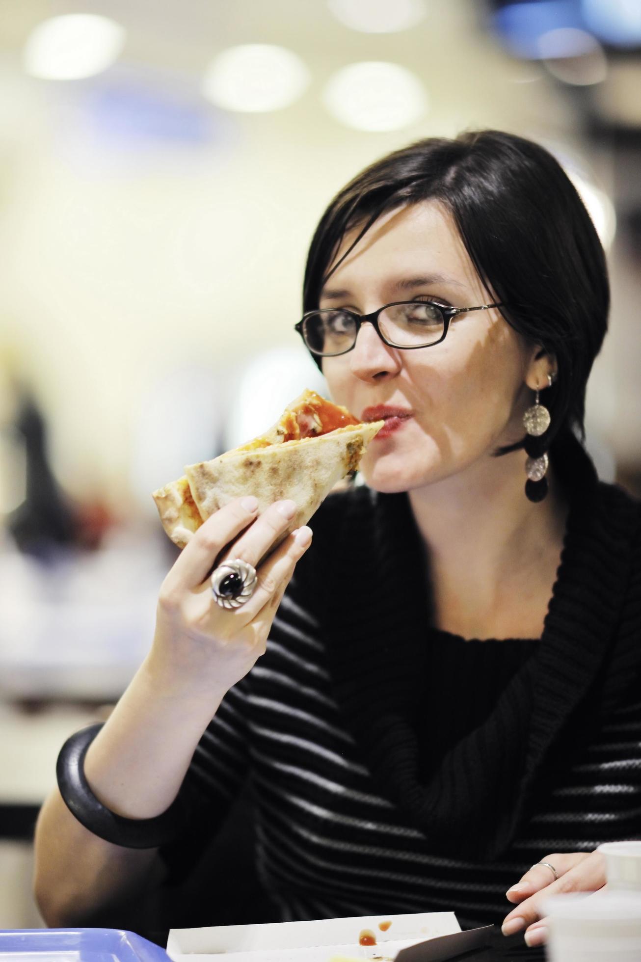 woman eat pizza food at restaurant Stock Free