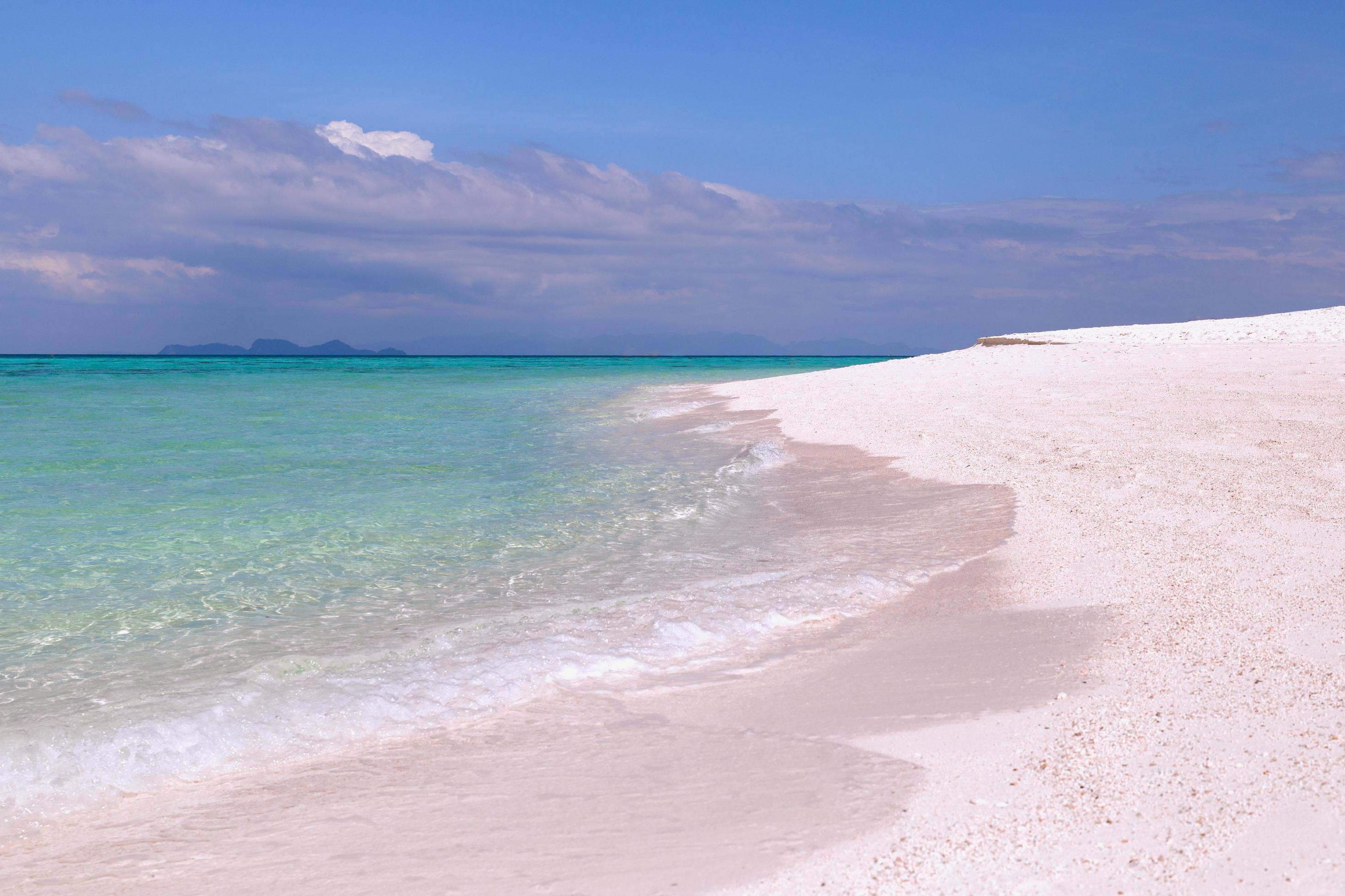 Beautiful ocean with white sandy beach and blue sky in tropical island. Stock Free