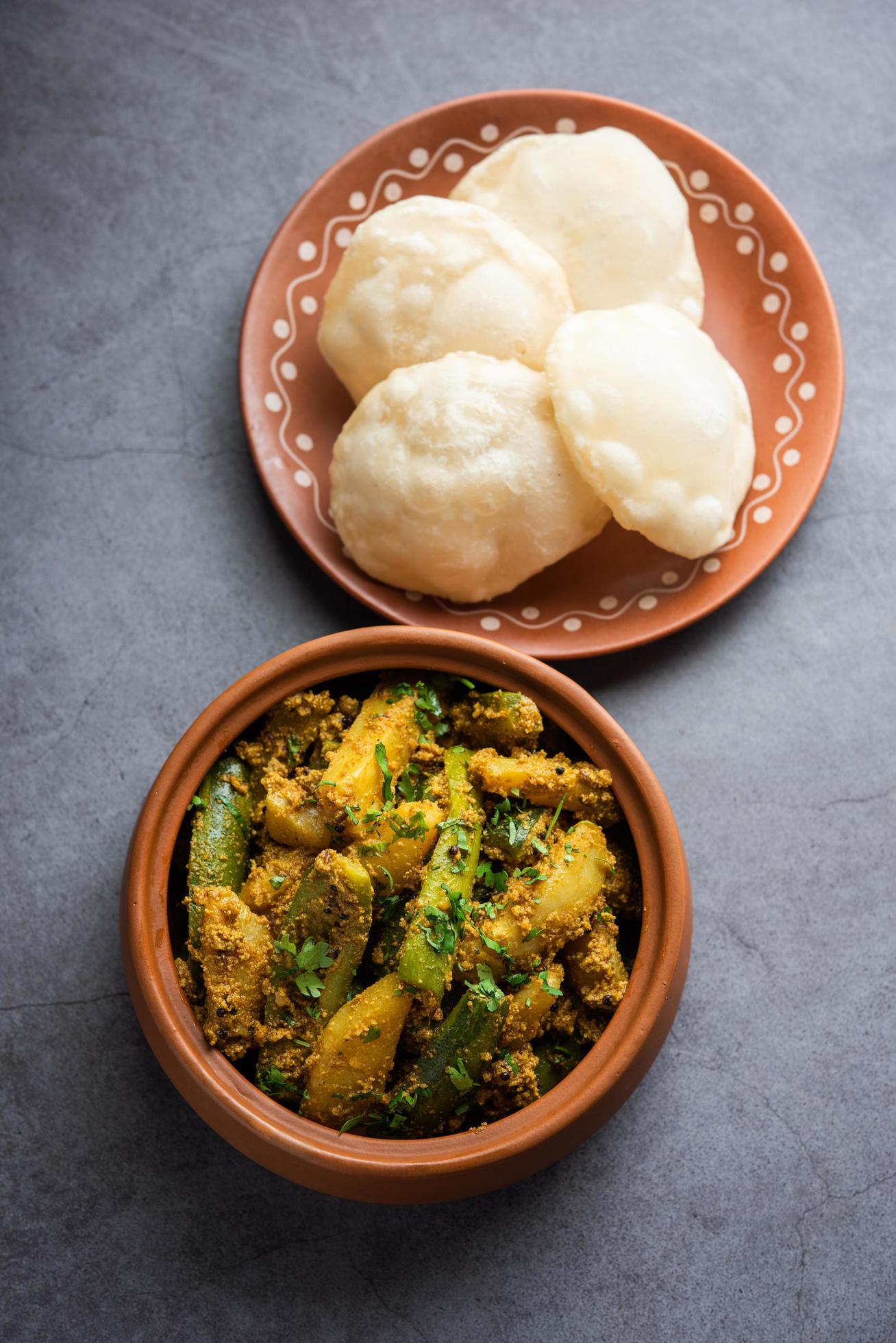 Aloo Patol sabzi made using pointed gourd and potato served with fried Luchi or poori, Bengali food Stock Free