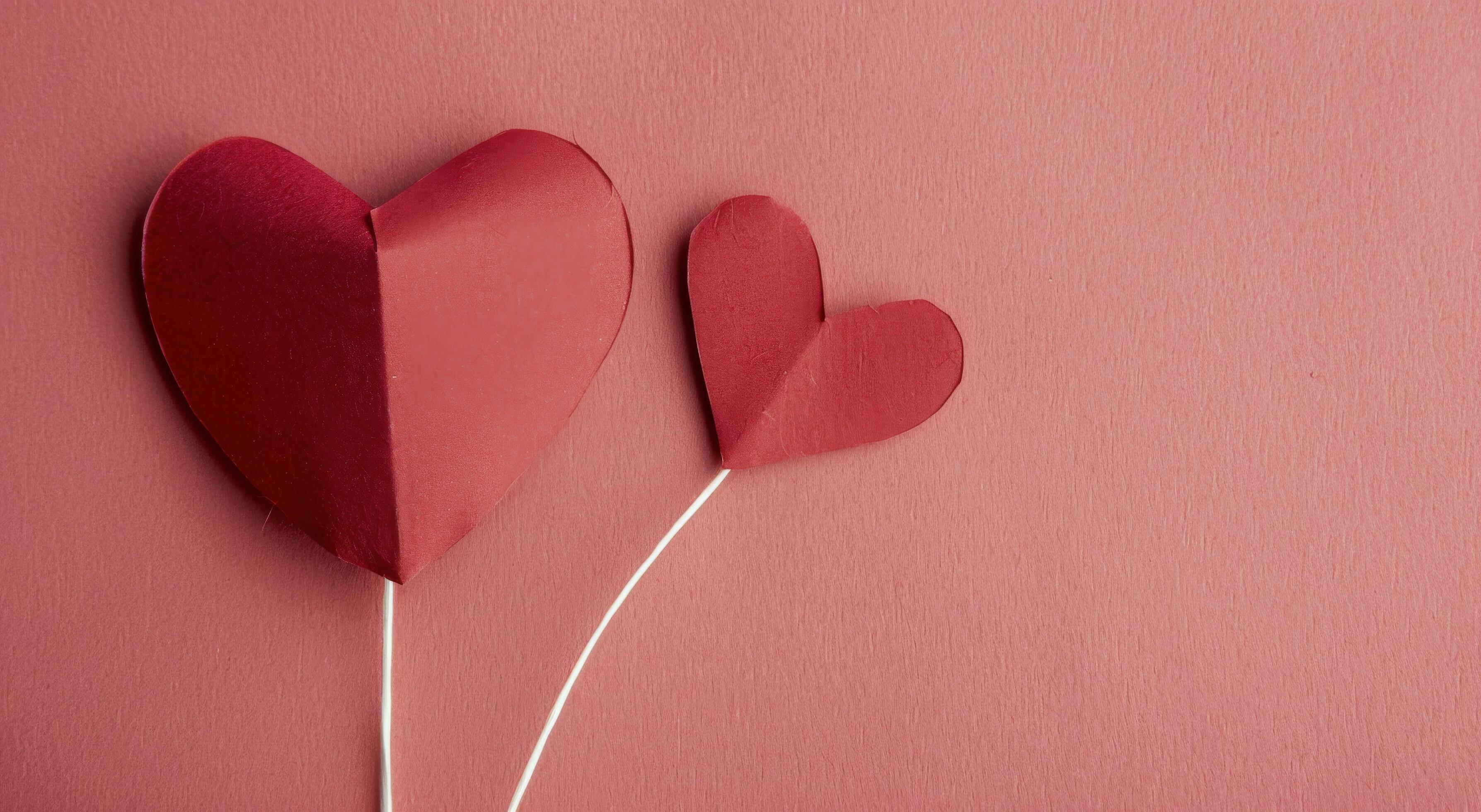 Red Paper Hearts on a Pink Background for Valentine’s Day Celebration Stock Free