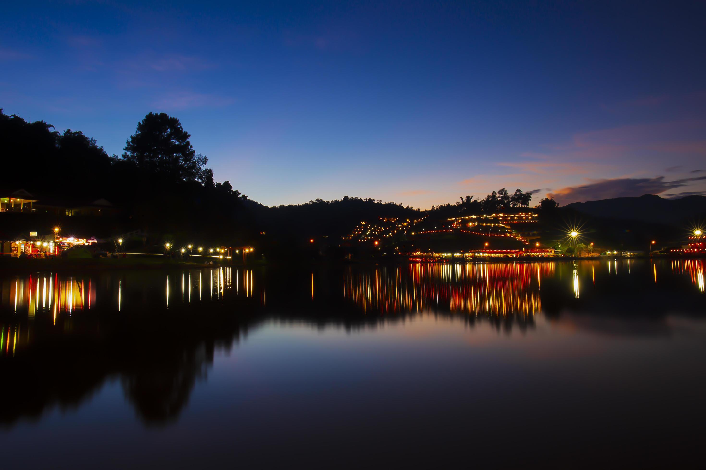 Mae Hong Son Thailand October 31 2021 Baan Rak Thai Village Light from lamps reflecting on the River Sunset Twilight. Stock Free