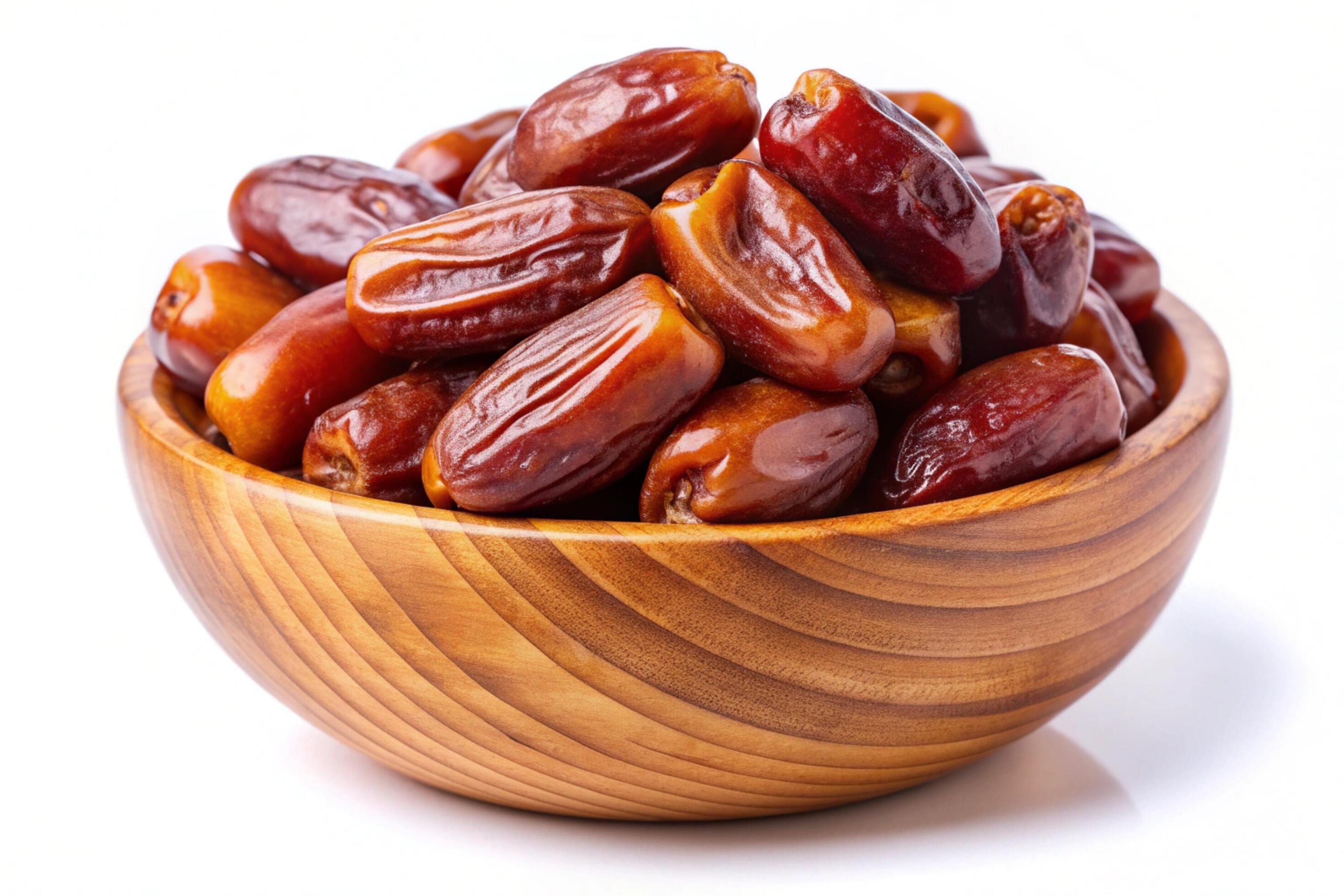 Dates in wood bowl isolated on white background Stock Free