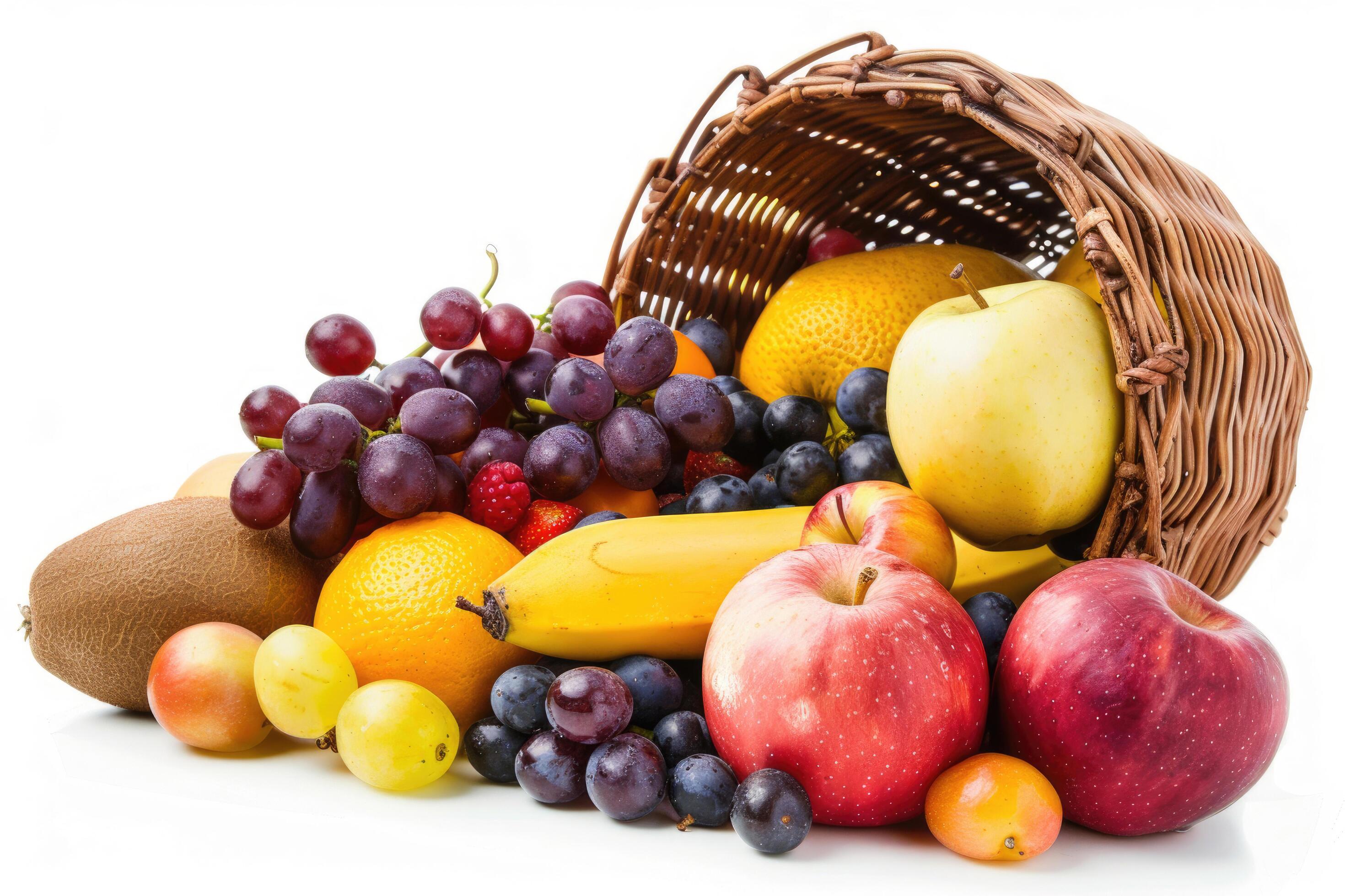 A selection of fresh fruits spilling from a basket on a white background Stock Free