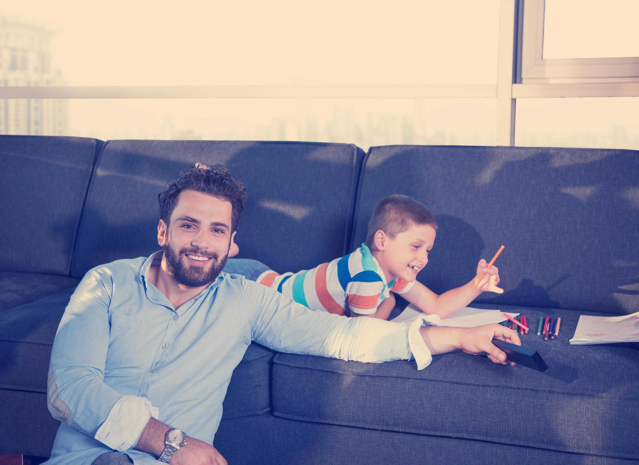 Happy Young Family Playing Together on sofa Stock Free