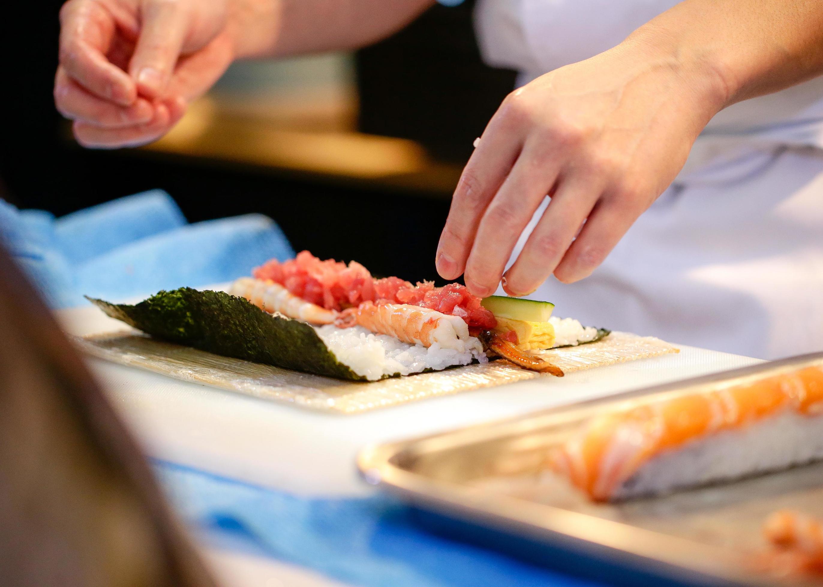 chef hands preparing japanese food, chef making sushi Stock Free