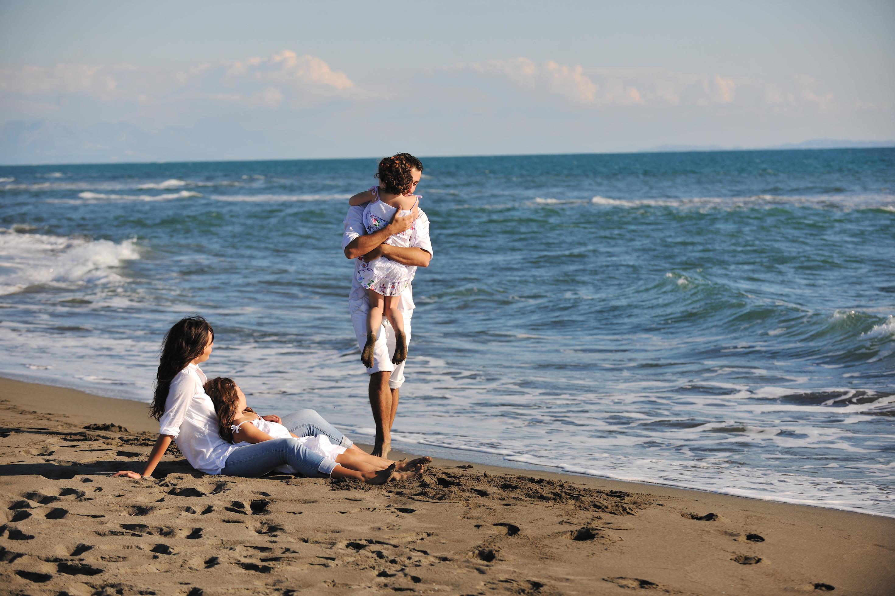 happy young family have fun on beach Stock Free