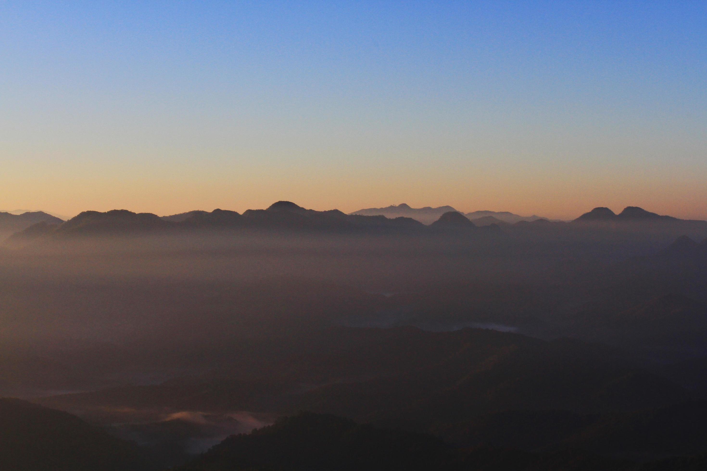 Beautiful Sunset and sunrise on sky and golden twilight time with mist and fog in valley of mountain layer Stock Free