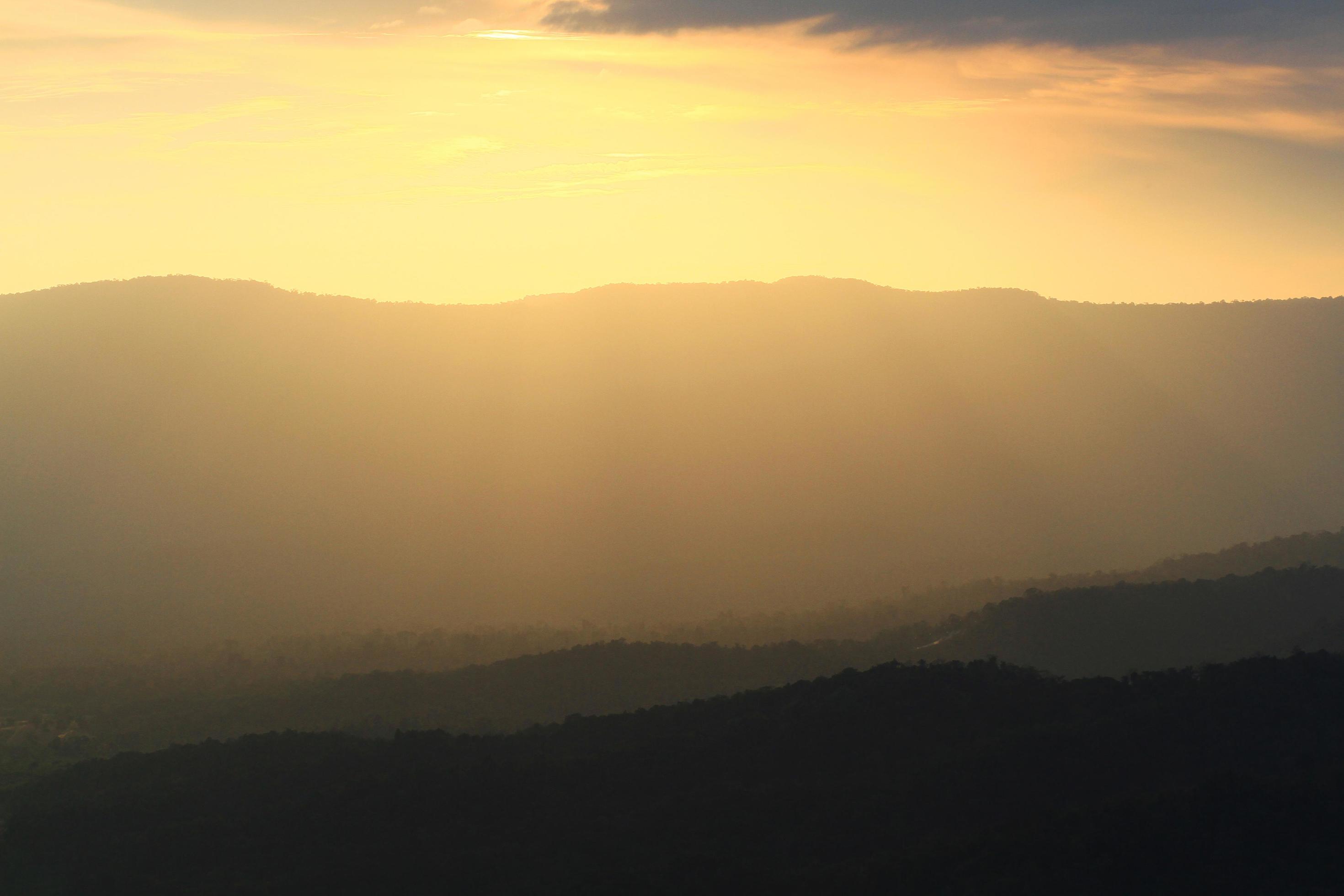 Beautiful landscape layers of mountain and Misty on hill valley in golden twilight of sunset at Thailand Stock Free