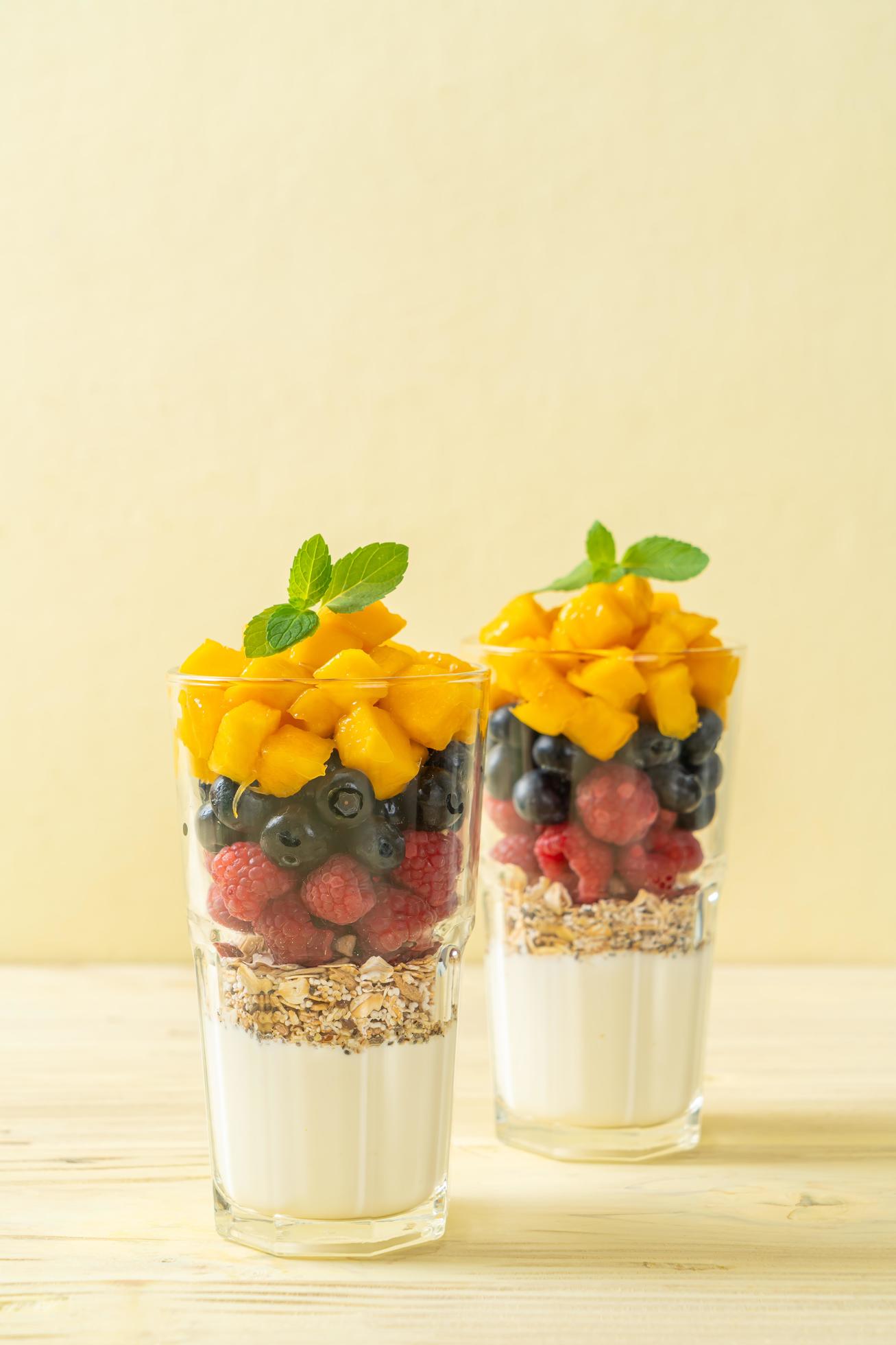 Homemade mango, raspberry, and blueberry with yogurt and granola – healthy food style Stock Free