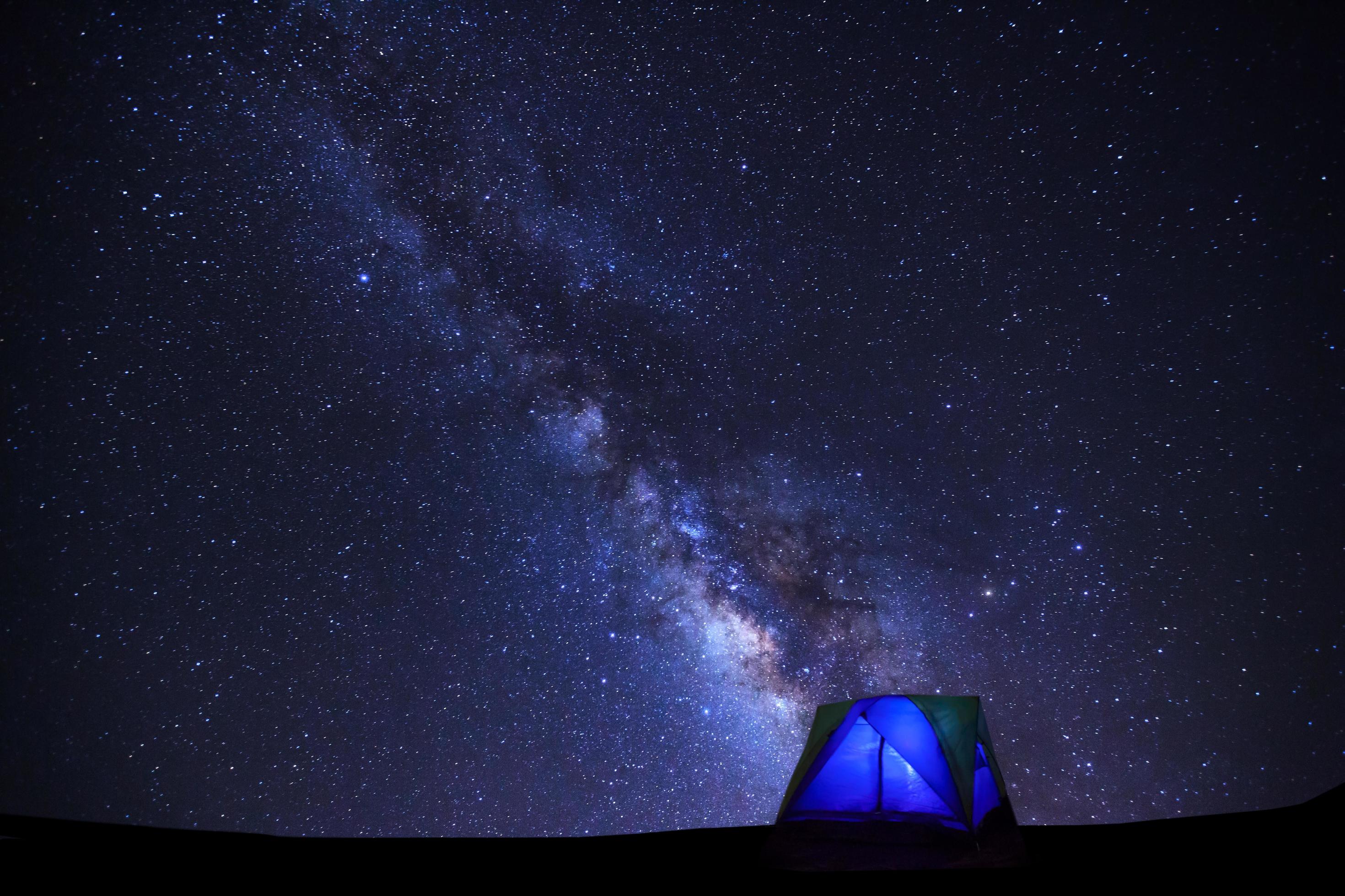 Landscape with milky way galaxy, Starry night sky with stars and silhouette of dome tent Stock Free