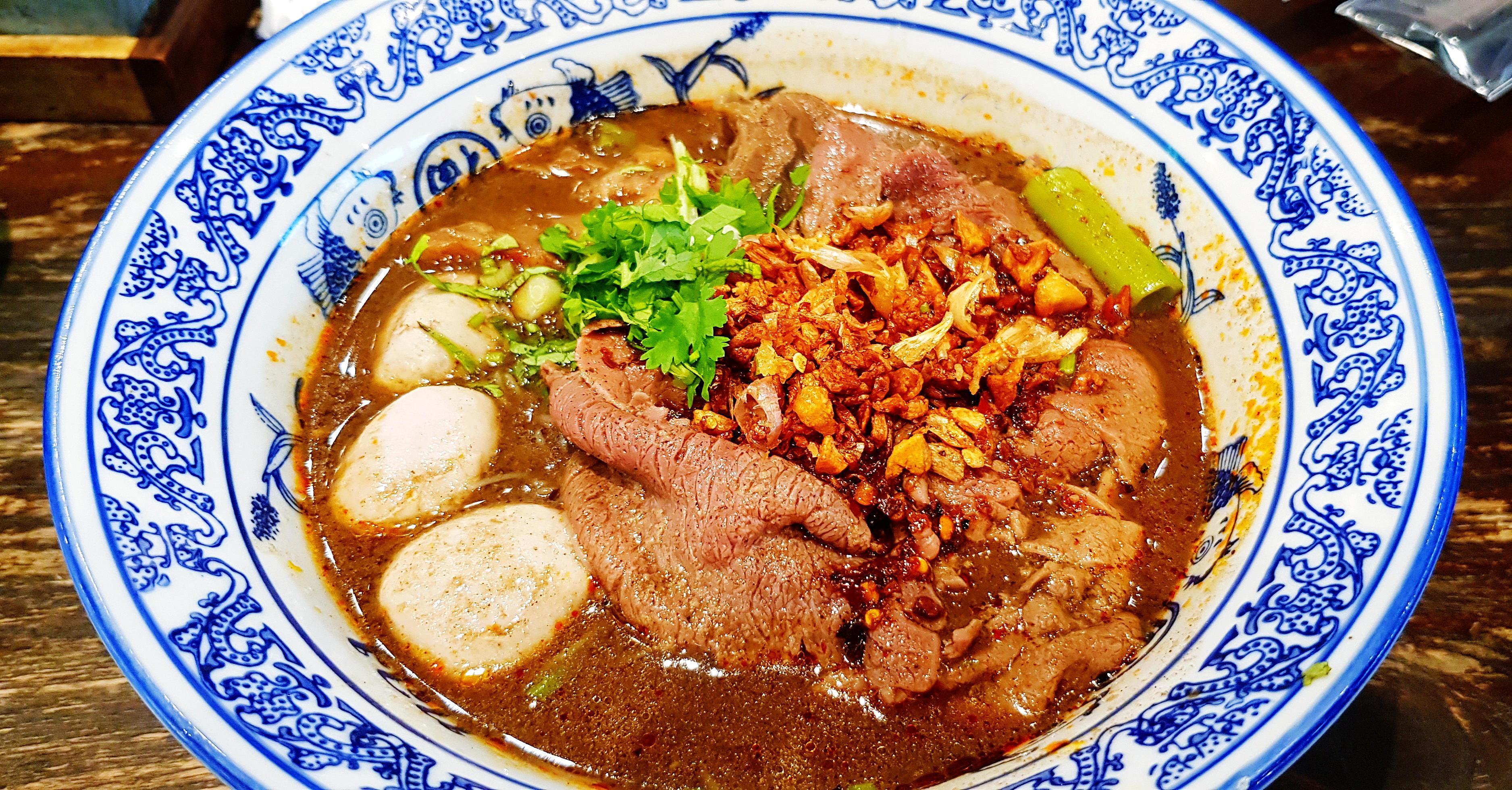 Close up Thai noodle with Australian Wagyu beef, stewed pork, meatball, liver and blood soup on bowl. The famous food in Thailand and Asia. Stock Free