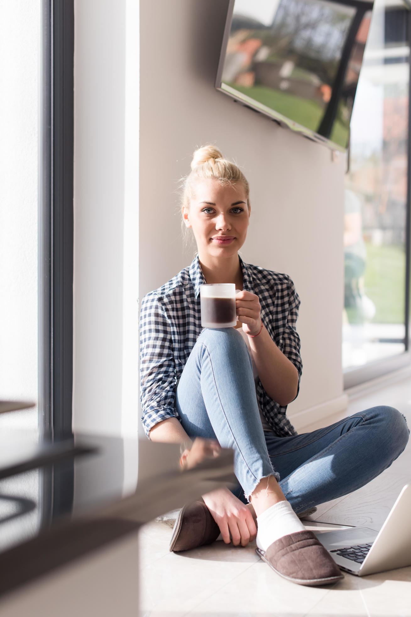 young woman drinking coffee enjoying relaxing lifestyle Stock Free