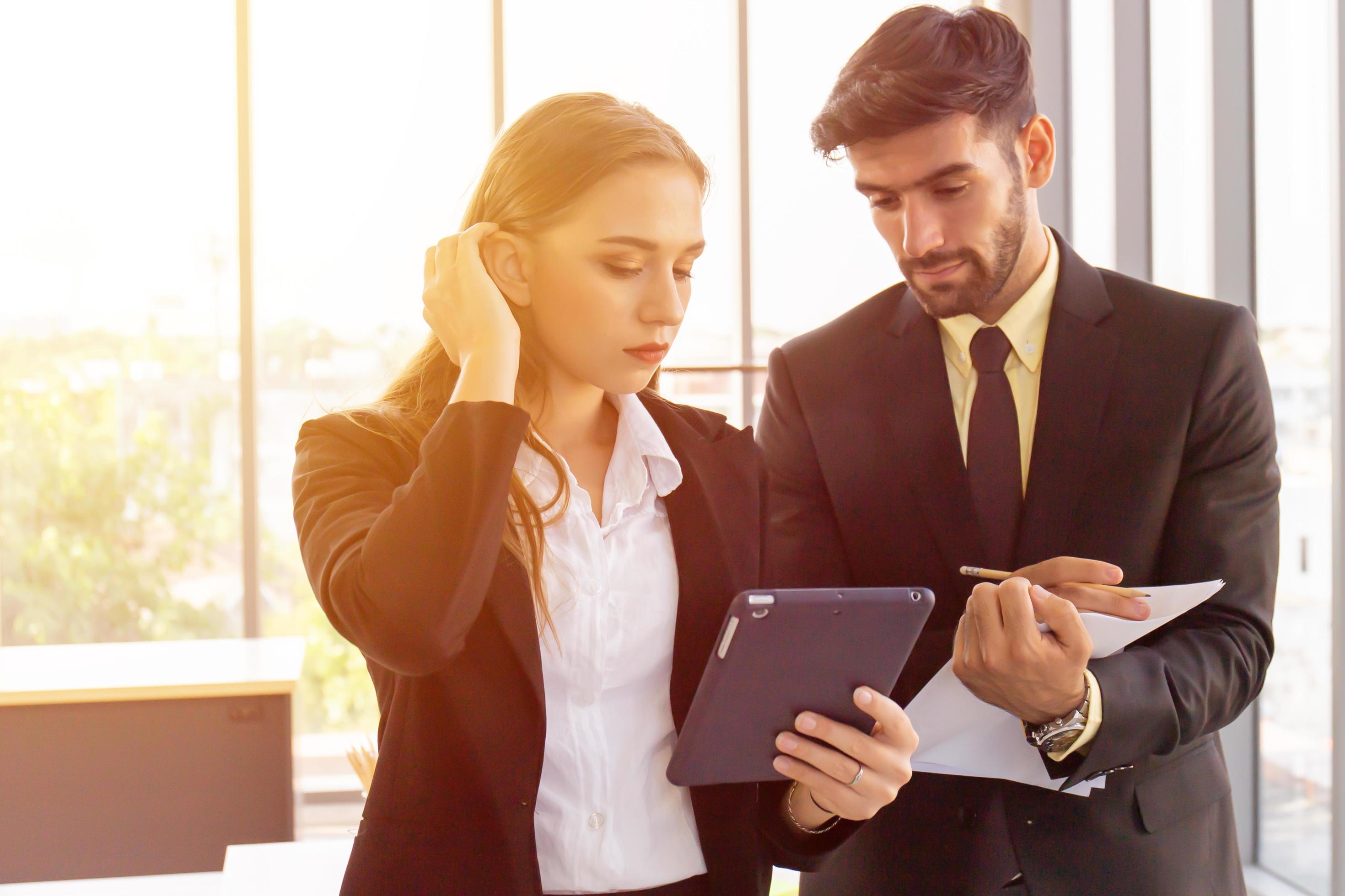 Two business men and women standing meeting in the office Stock Free