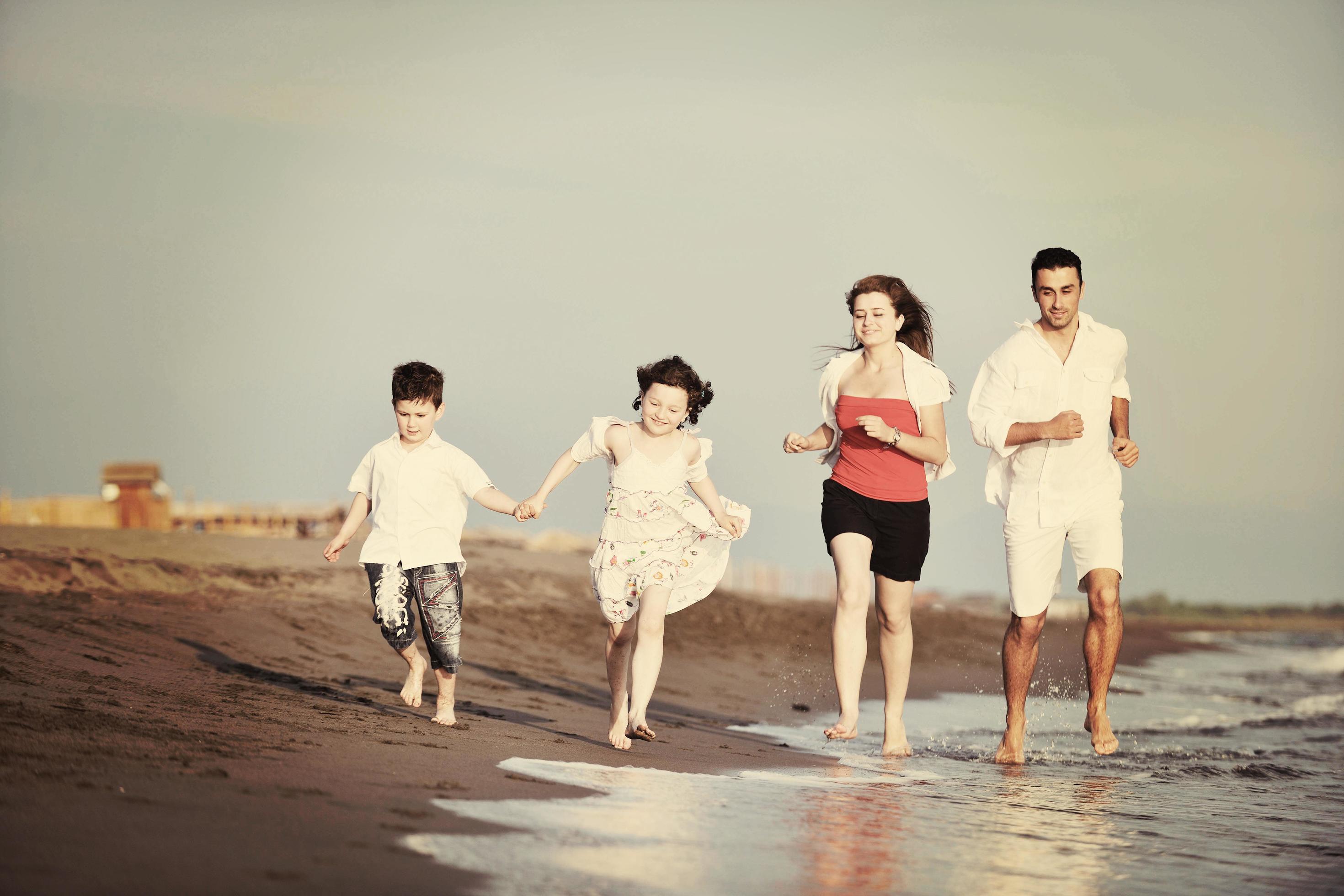 happy young family have fun on beach Stock Free