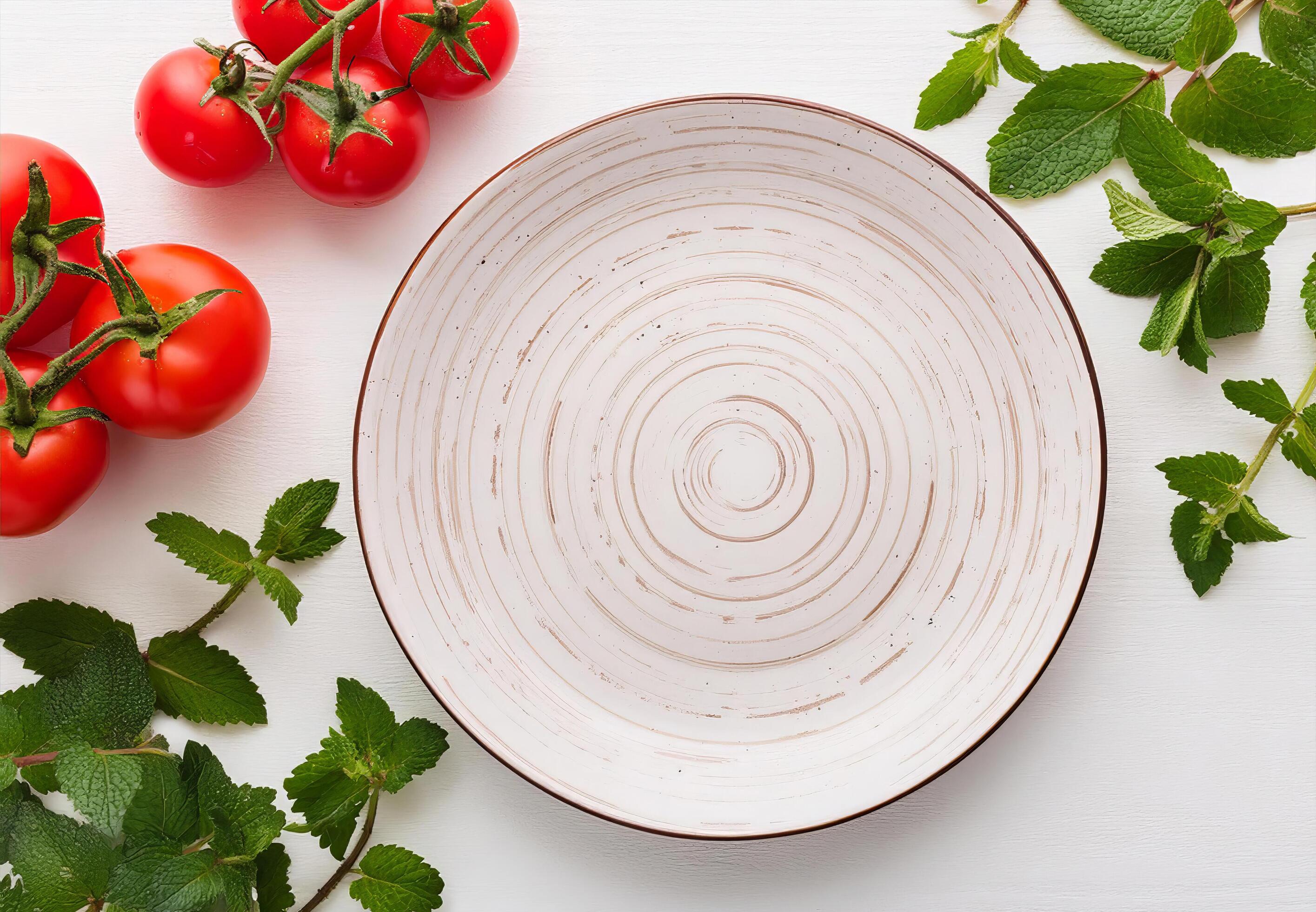 Empty ceramic plates on white wood table with kitchen Peppermint and red tomato Stock Free