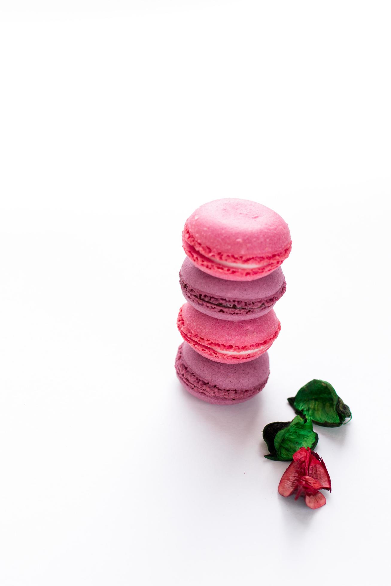 Bright macaroons on white background. Sweet food wallpaper with place for text. Stock Free