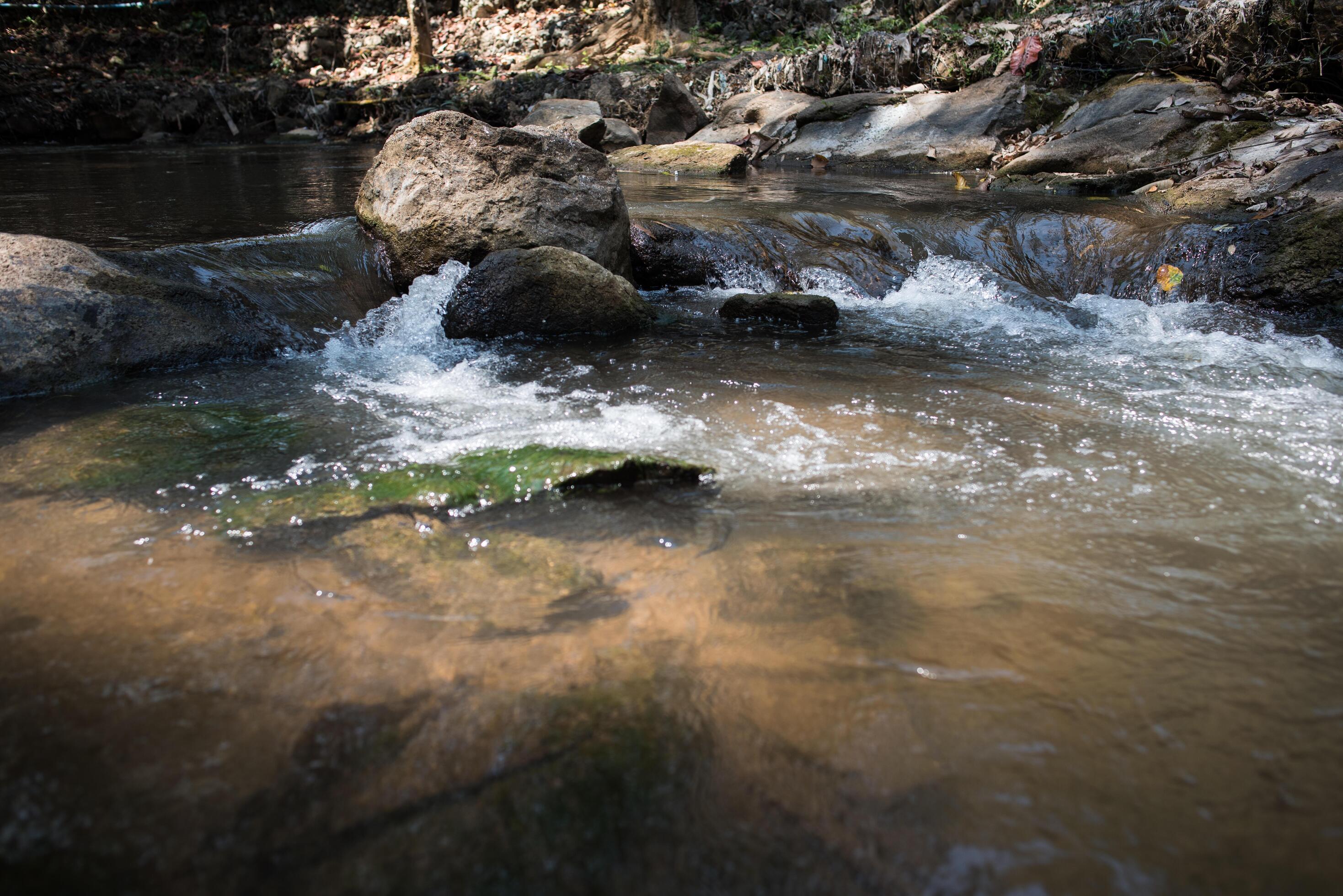 Waterfall in the nature and stone background Stock Free