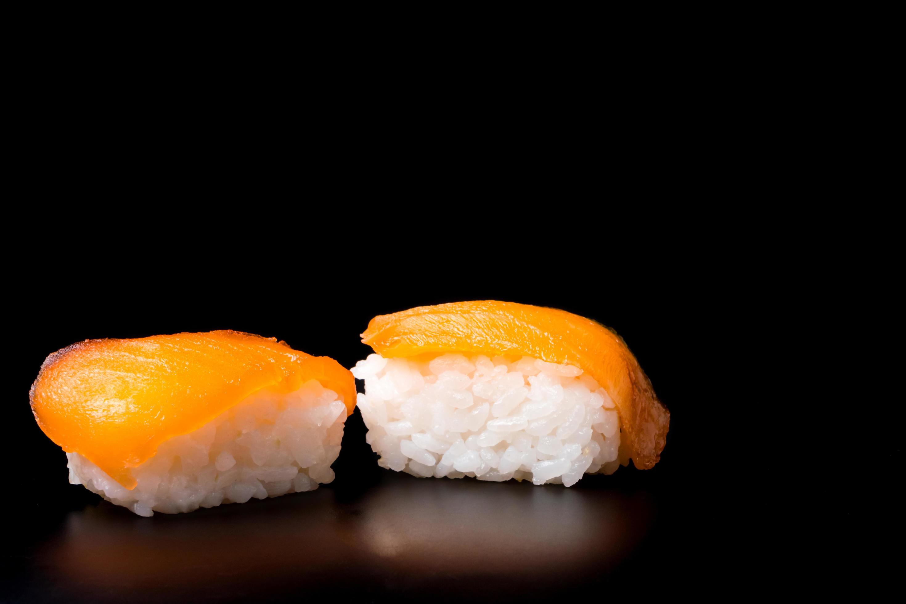 Sushi, japanese food, rice with salmon on black background. Stock Free