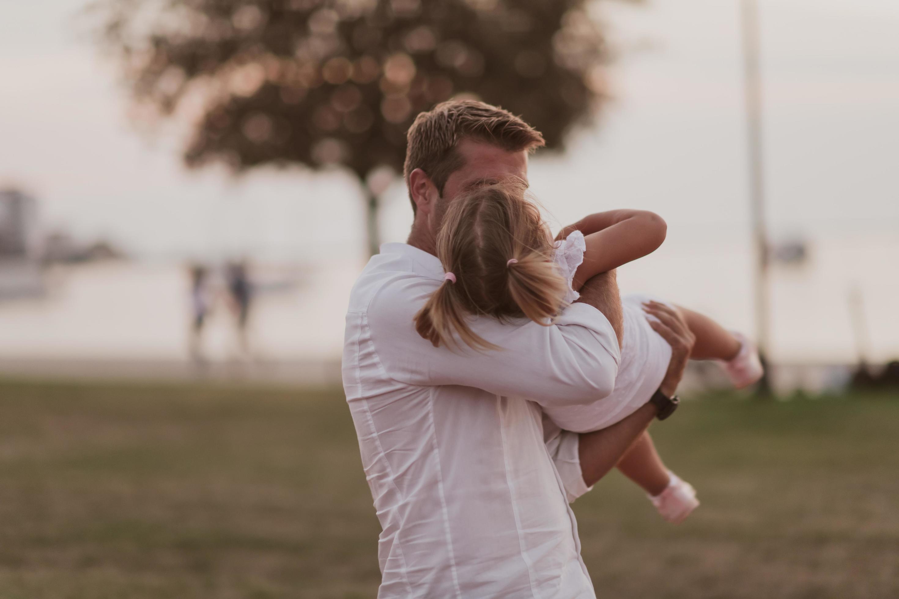 An elderly man in casual clothes with his daughter spends time together in the park on vacation. Family time. Selective focus Stock Free